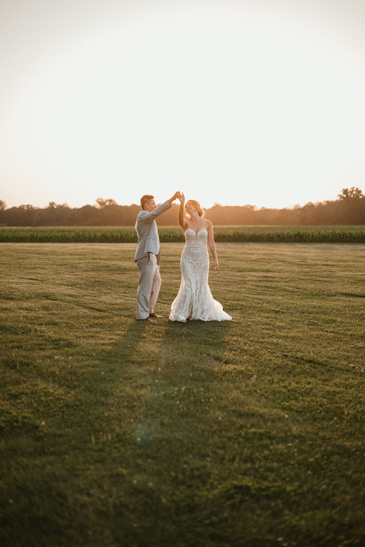 Bride and groom spinning together during playful golden hour portraits at Northstar Farms in Minnesota