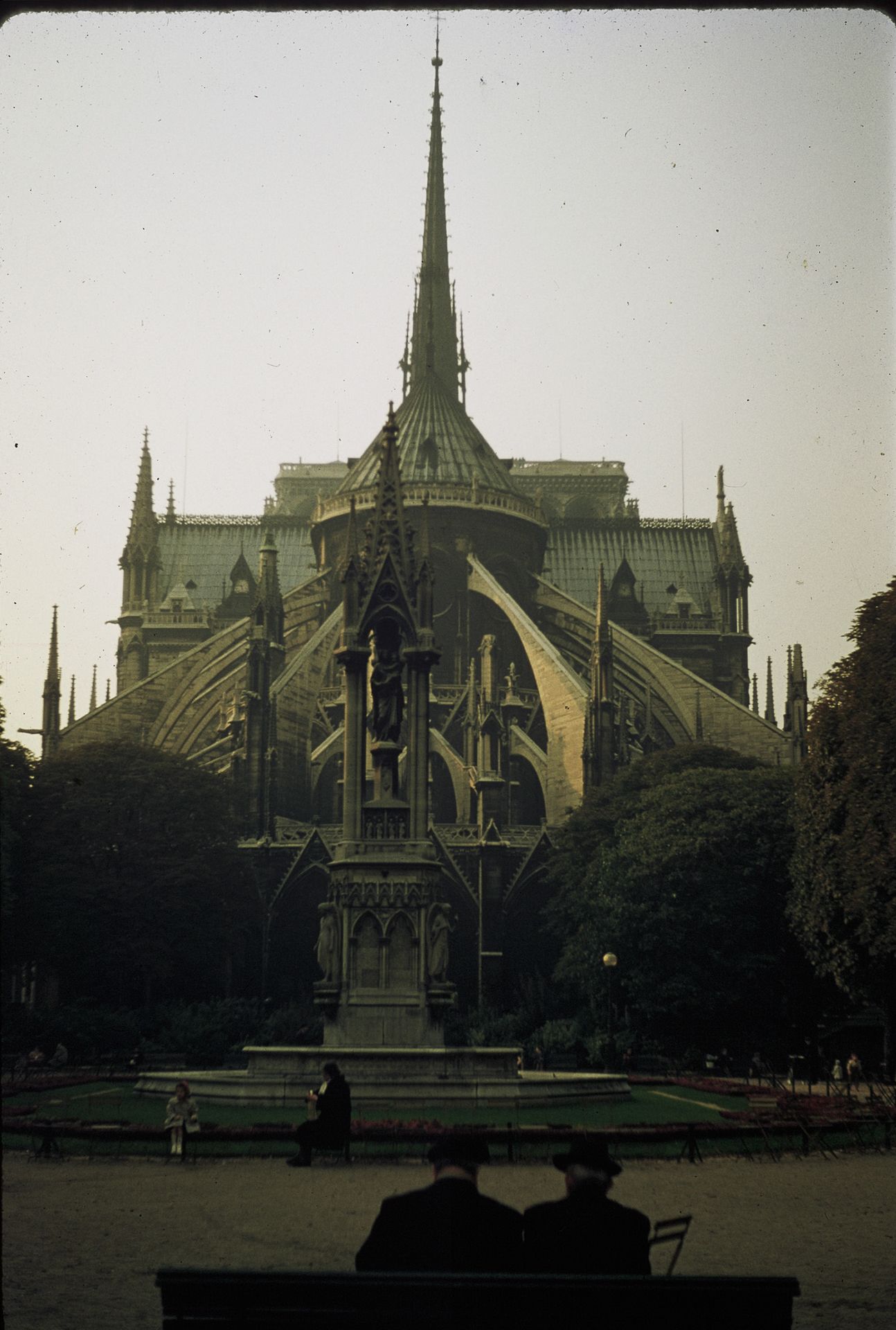 The rear facade of Notre-Dame Cathedral in Paris with Gothic spires and flying buttresses.
