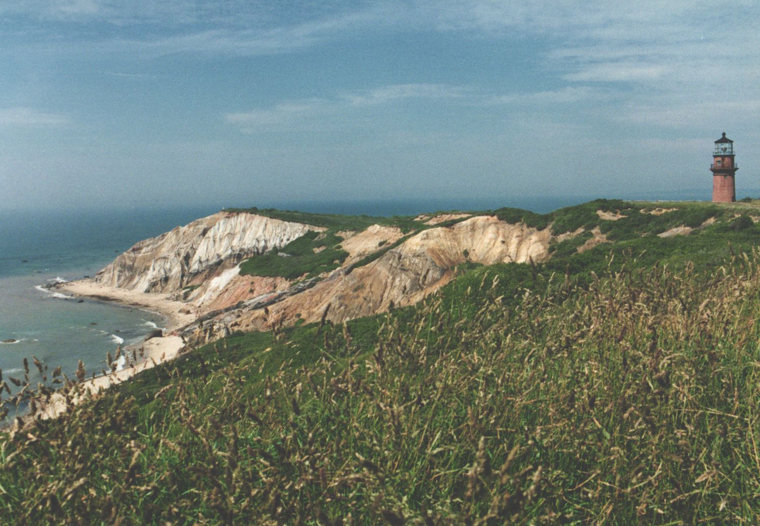 Gay Head Cliffs with red brick lighthouse overlooking ocean on Marthas Vineyard Massachusetts.