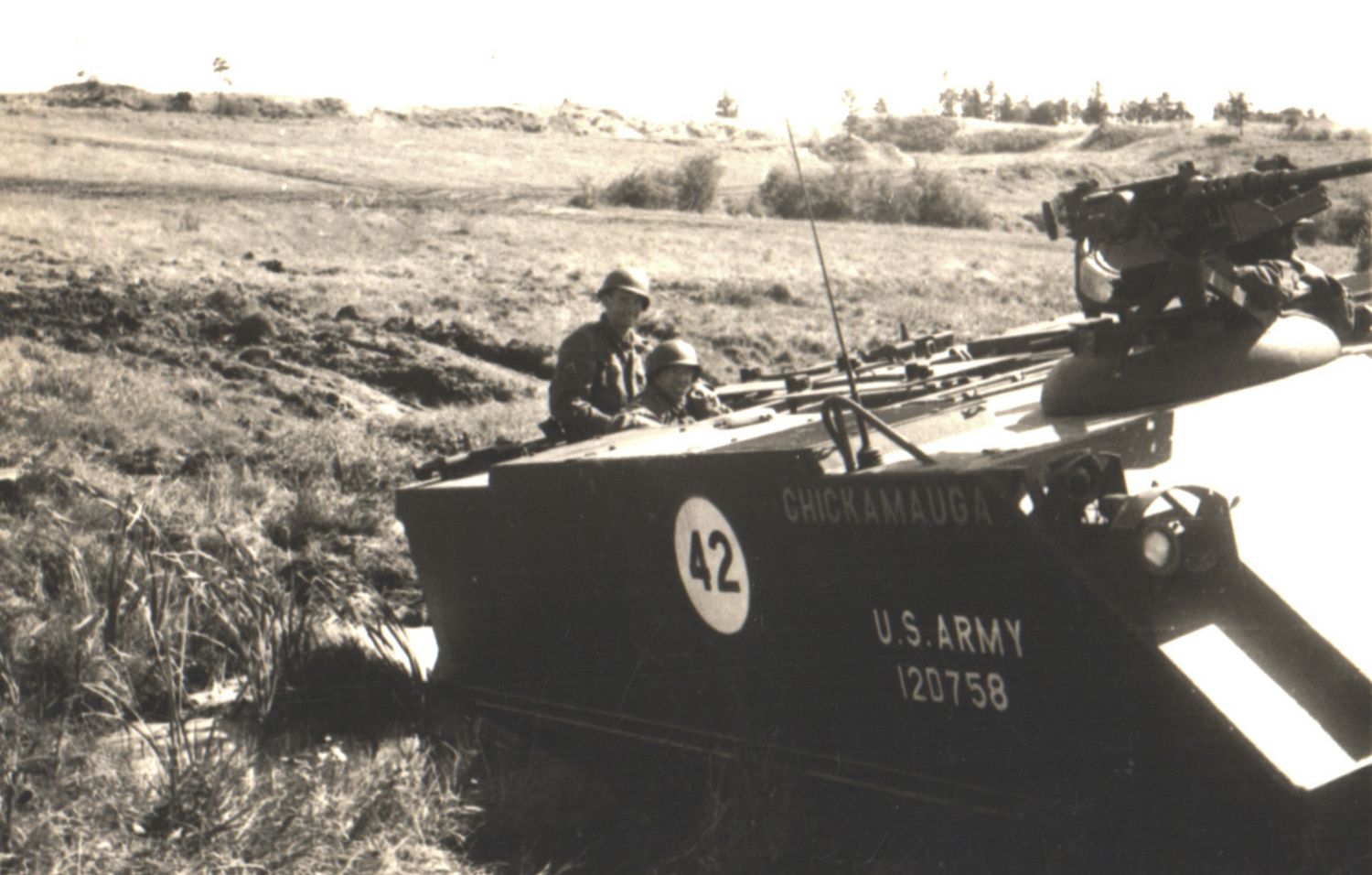 Vintage black and white photo of a U.S. Army amphibious vehicle number 42 with soldiers during a military operation.