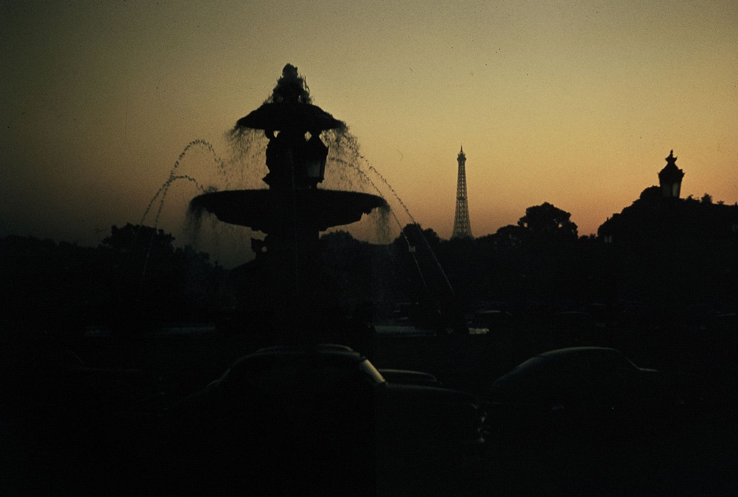 Silhouette of Eiffel Tower and fountain at sunset in Paris, France.