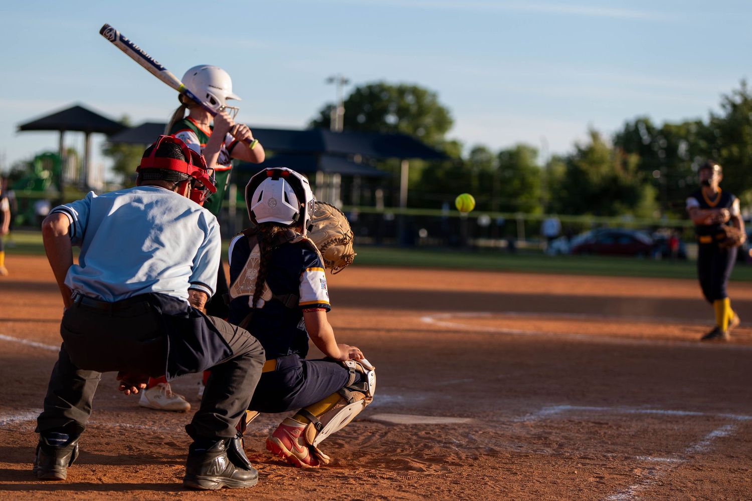 Youth softball game action at home plate during a North Georgia tournament