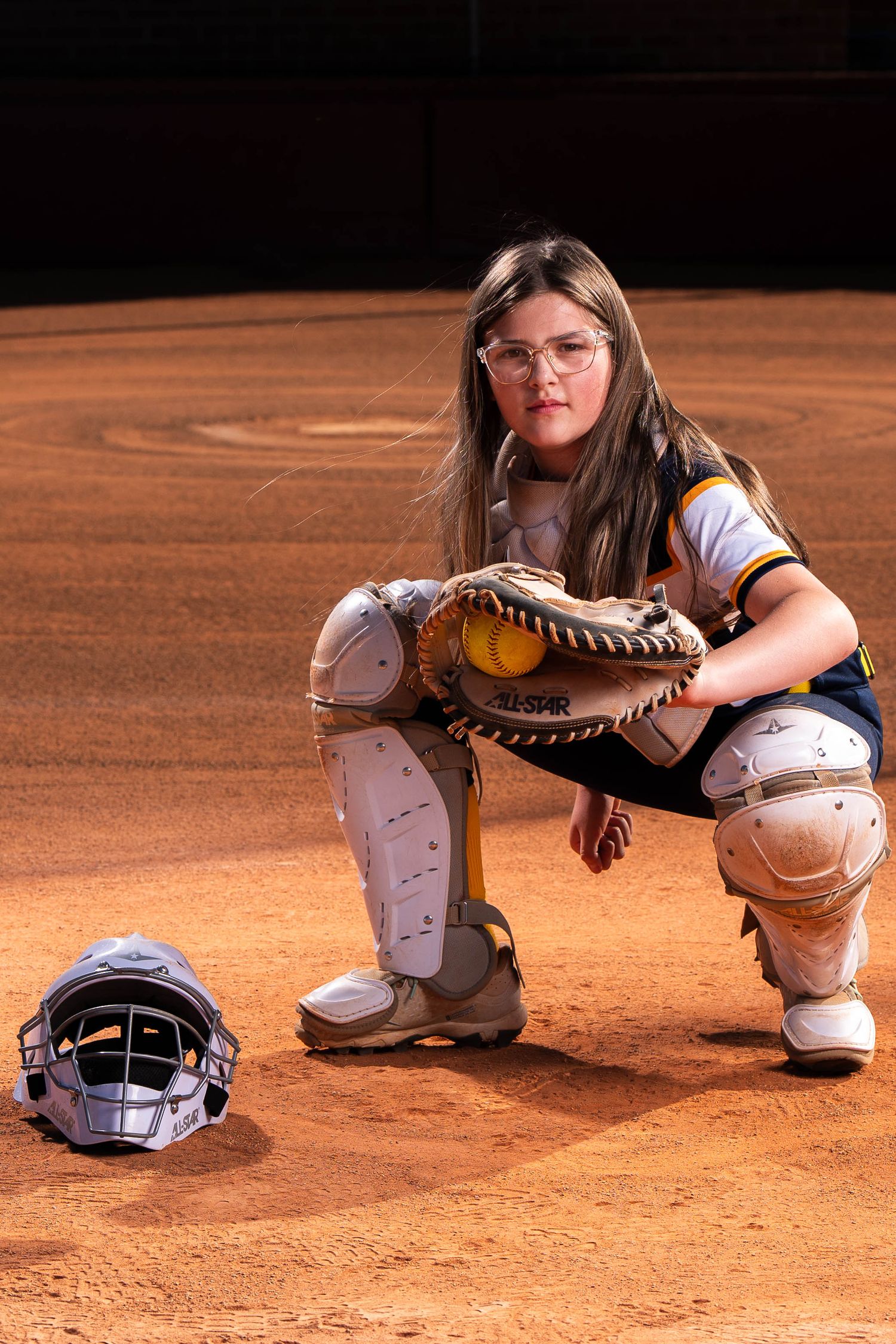 Youth softball catcher portrait during team media day photography session