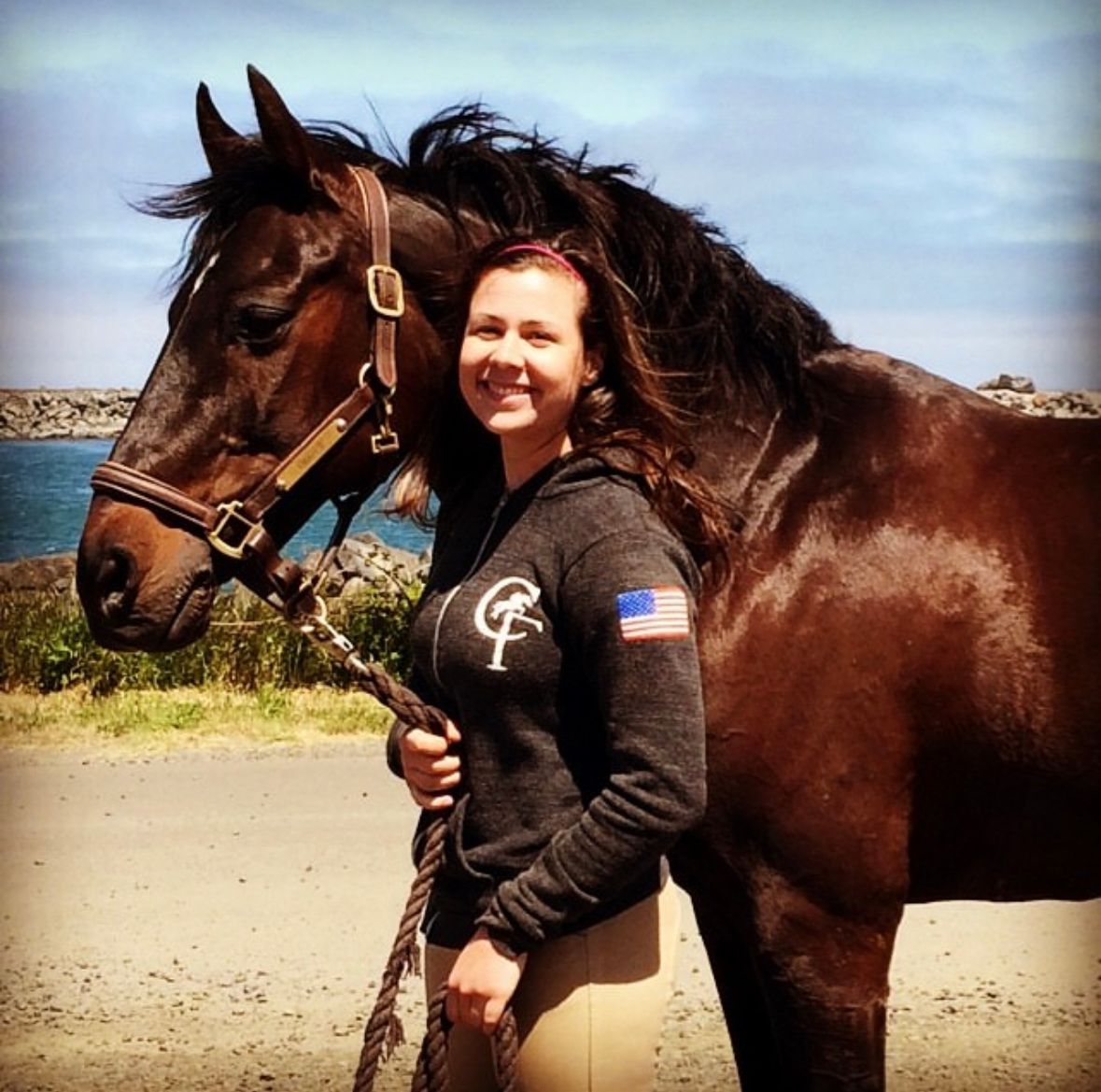A horse and rider pose for a picture after a beach ride.