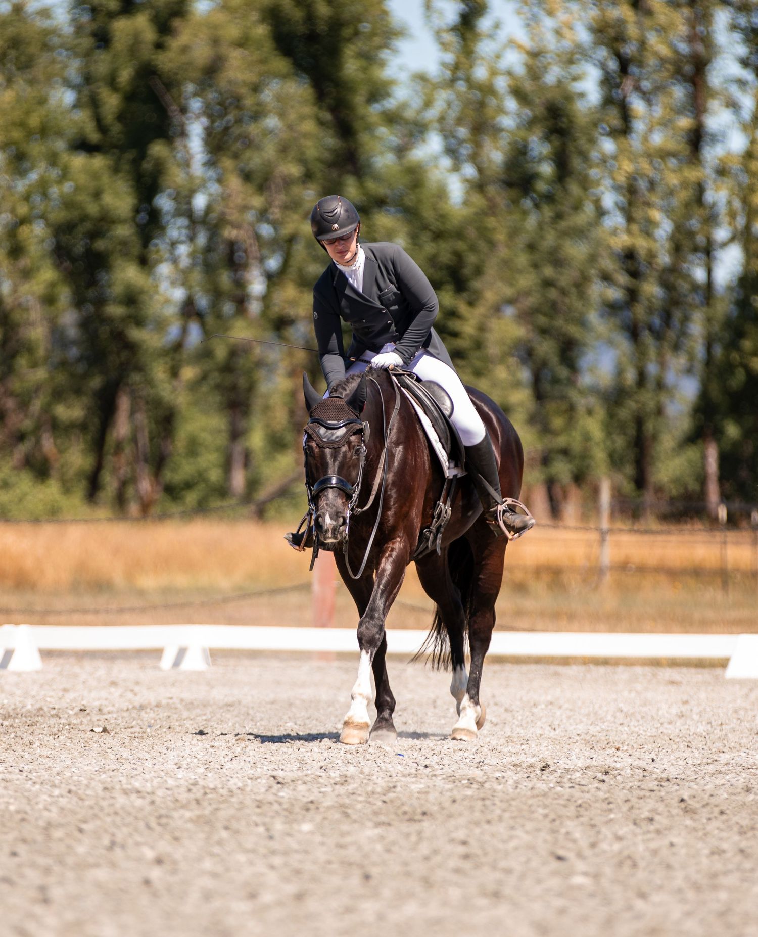 A rider gives her horse a pat on the neck after they finish their ride.