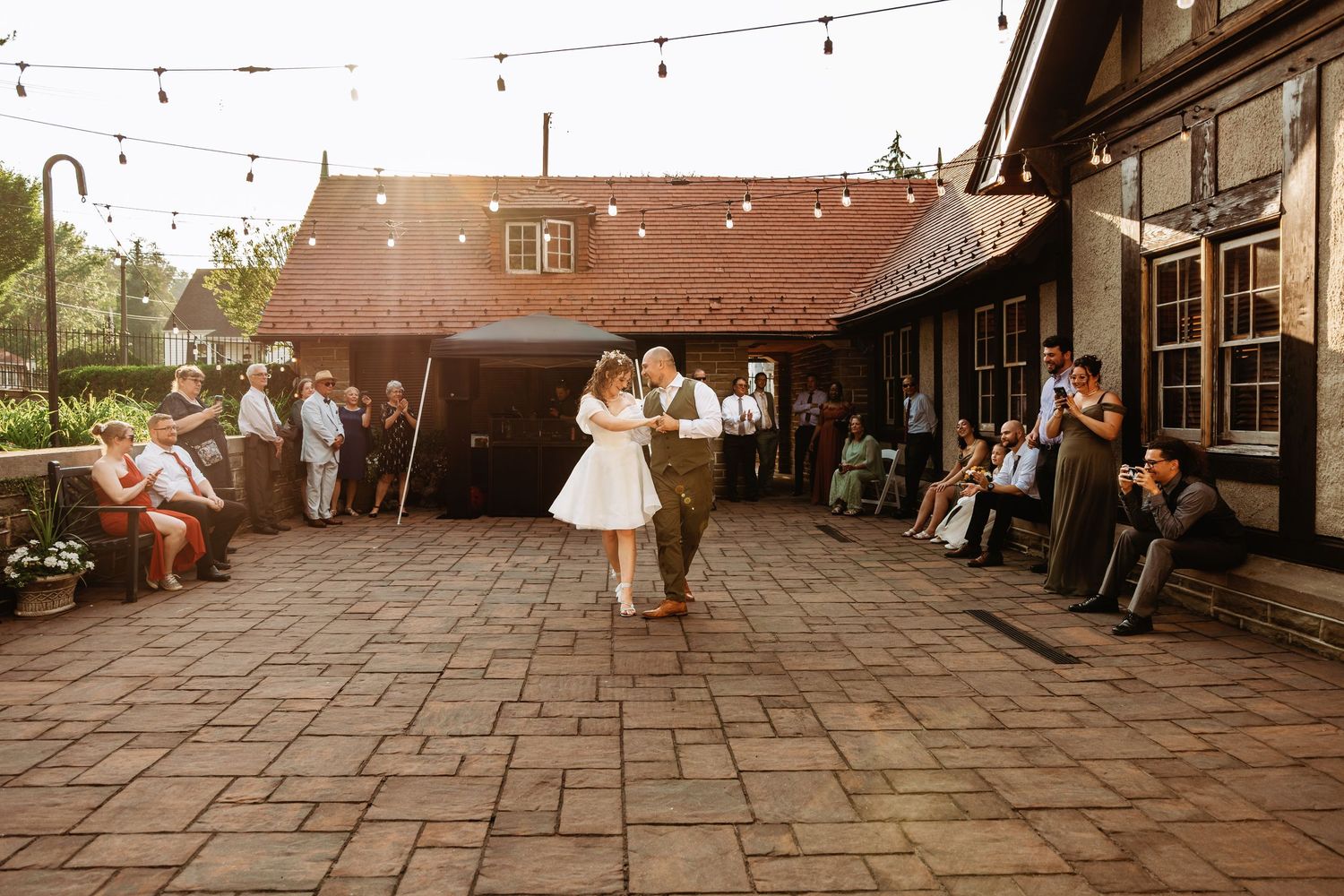 Bride and groom share a coordinated first dance on the patio at High Gate Carriage House in Fairmont, WV. | Wedding Photographer in Fairmont