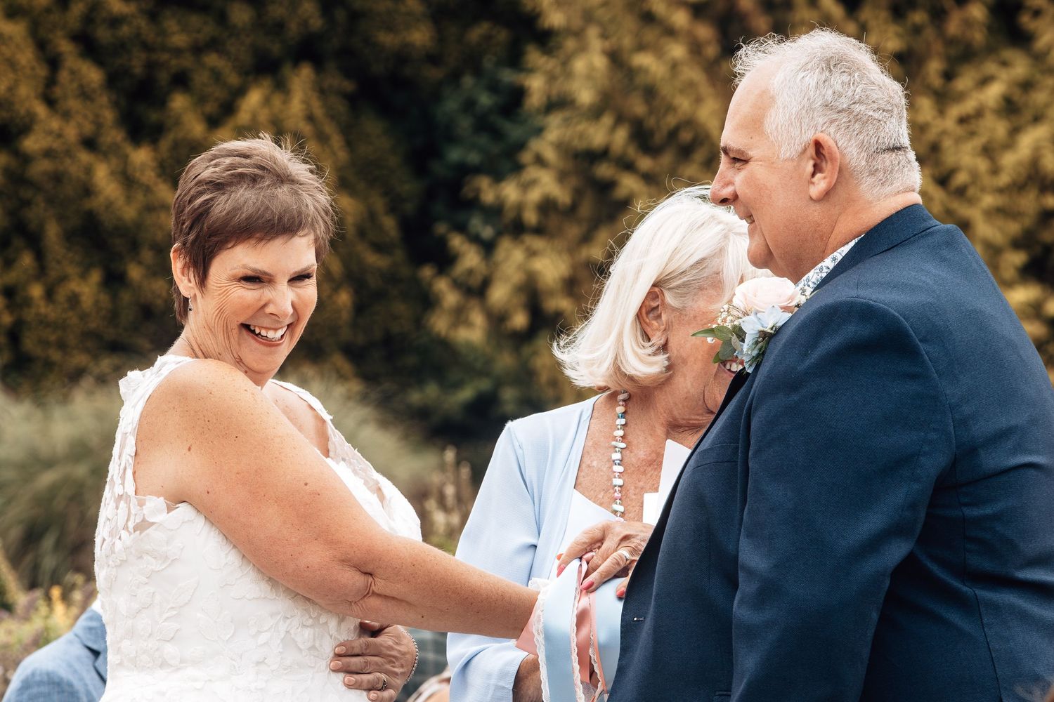 Candid moments shared during outdoor wedding reception with natural lighting.