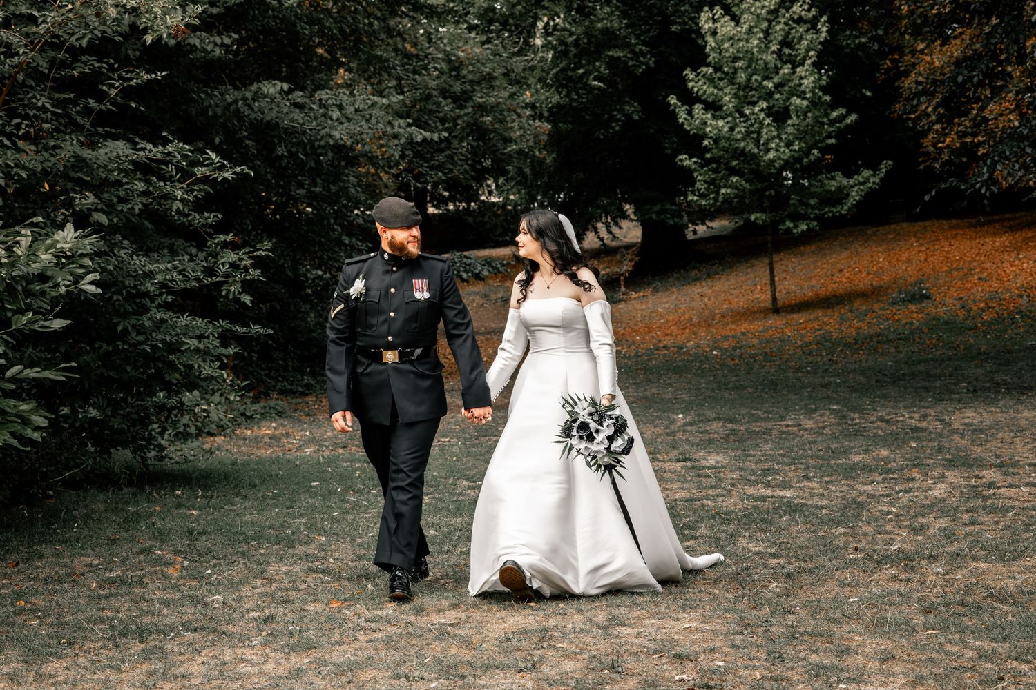 Elegant wedding photography session in an outdoor park with natural fall foliage.