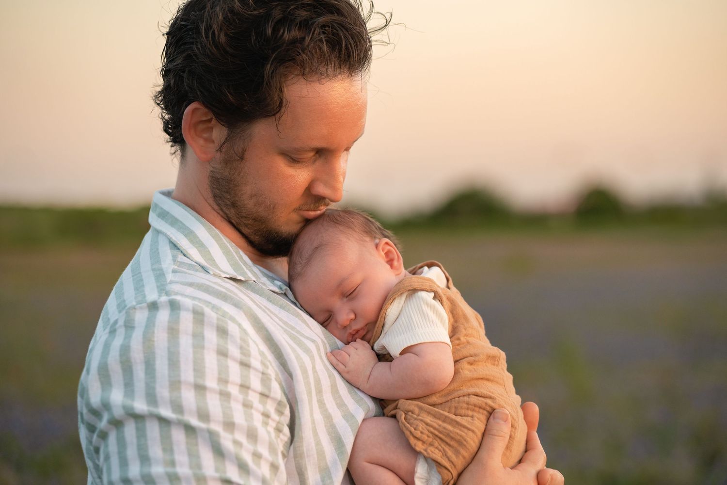A series of tender moments between a parent and infant against a warm, natural background.