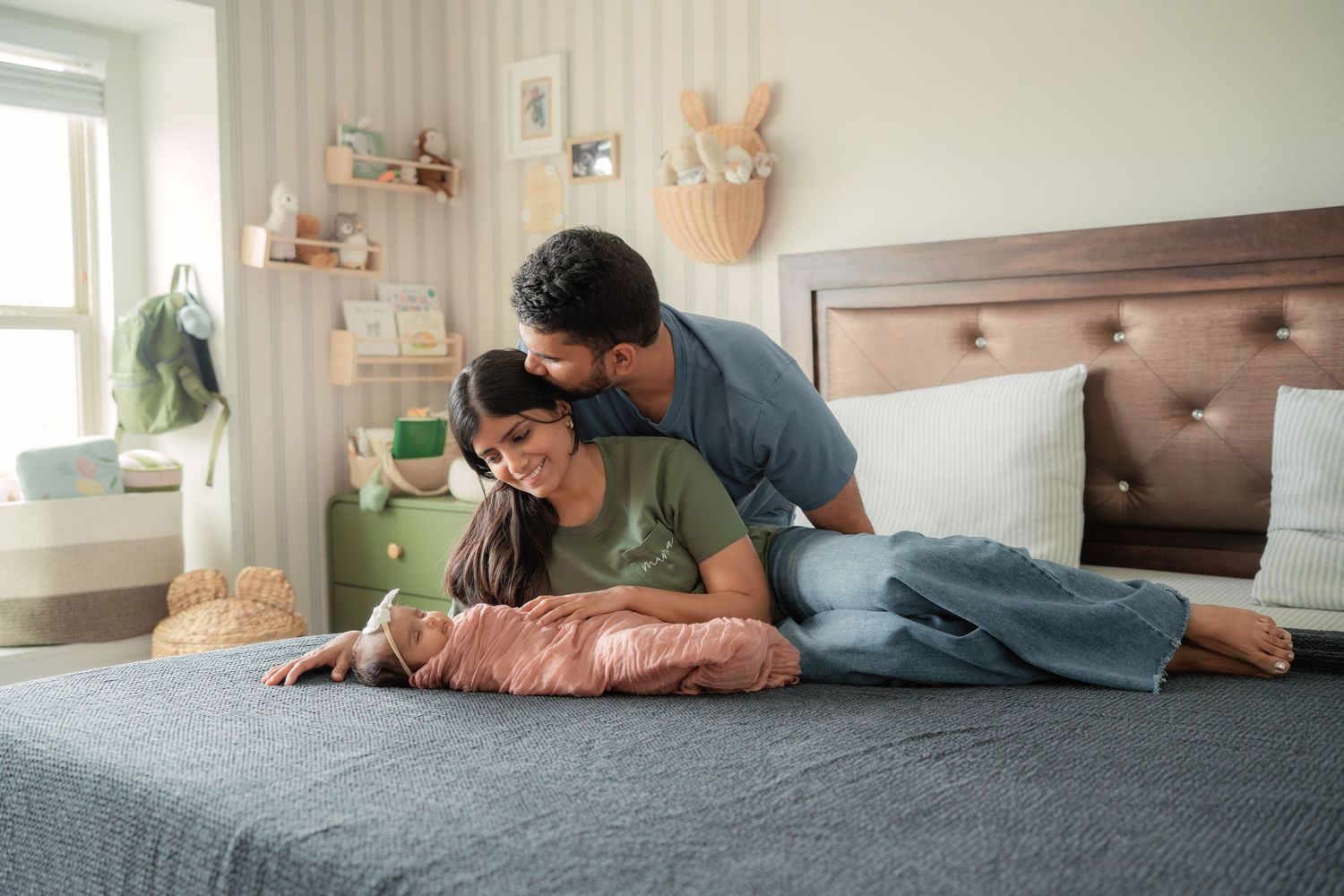 A couple relaxes together on a cozy bed in a warmly decorated bedroom, sharing a tender moment.