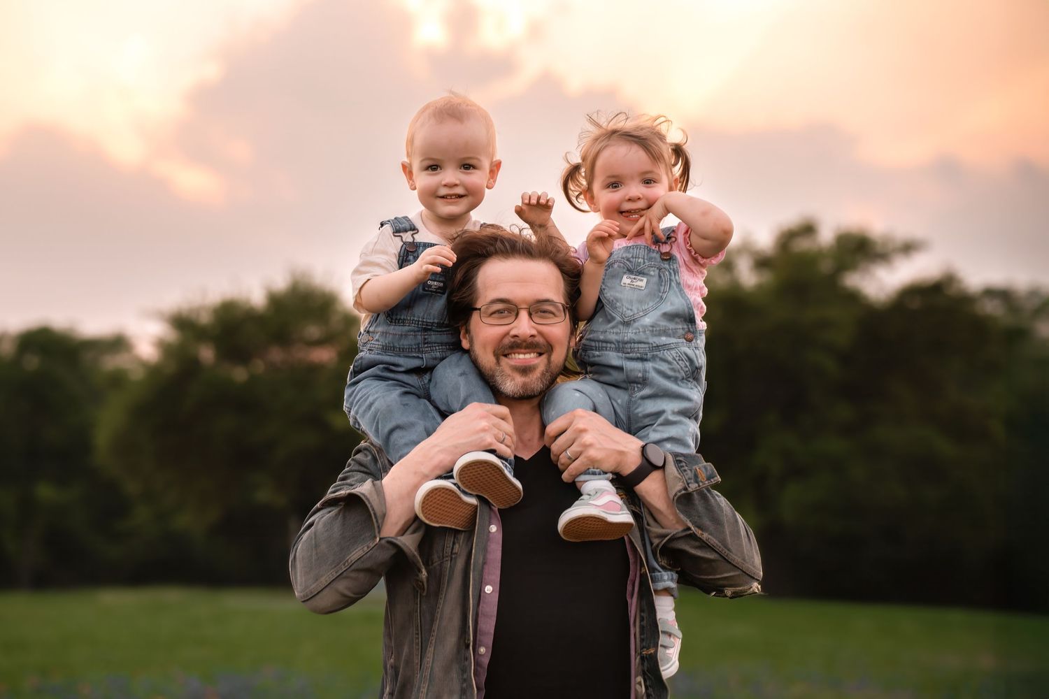 A series of joyful family photos showing parents holding and playing with their baby at sunset in a grassy field.