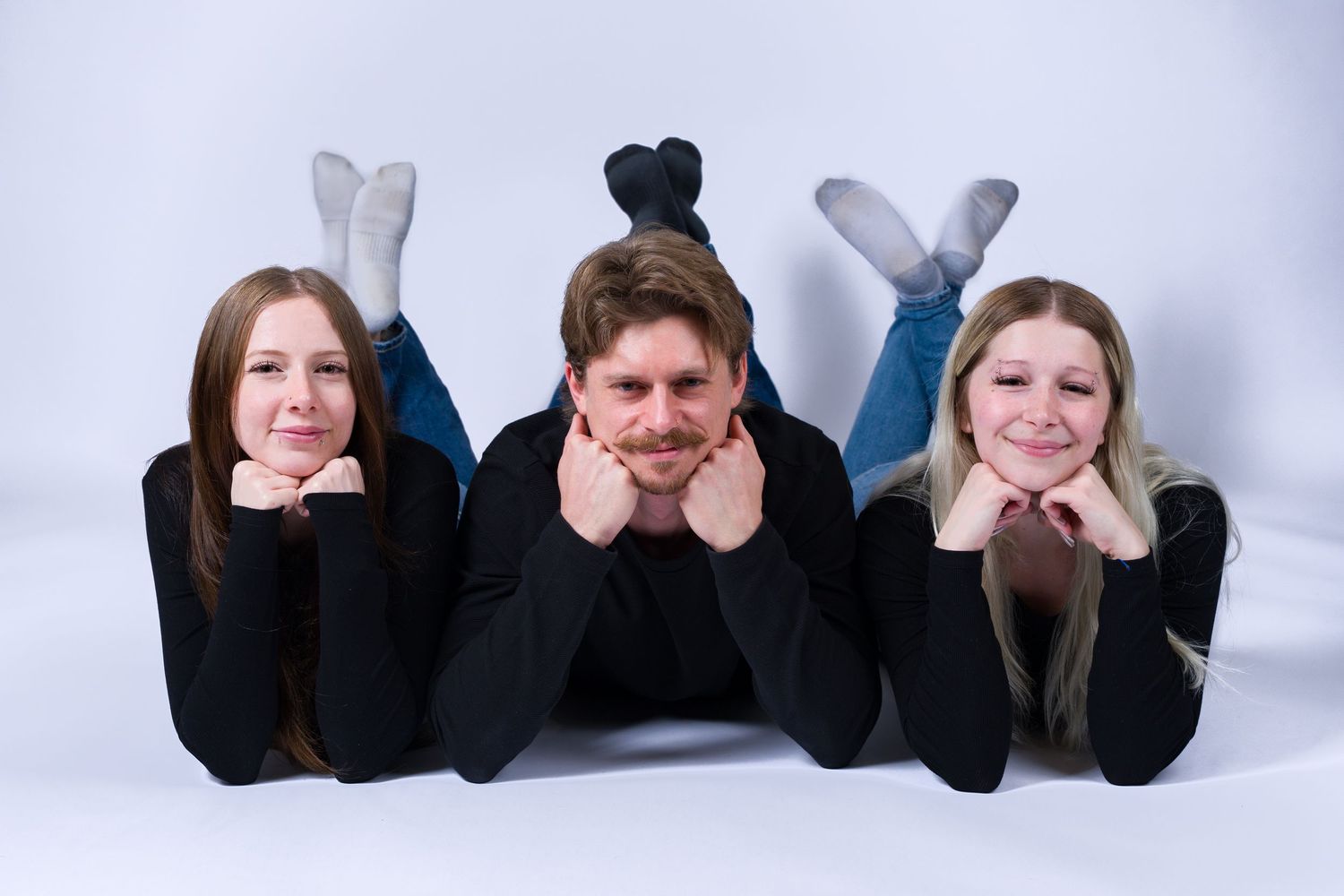 A series of five photos showing feet with black socks lined up against a white background.