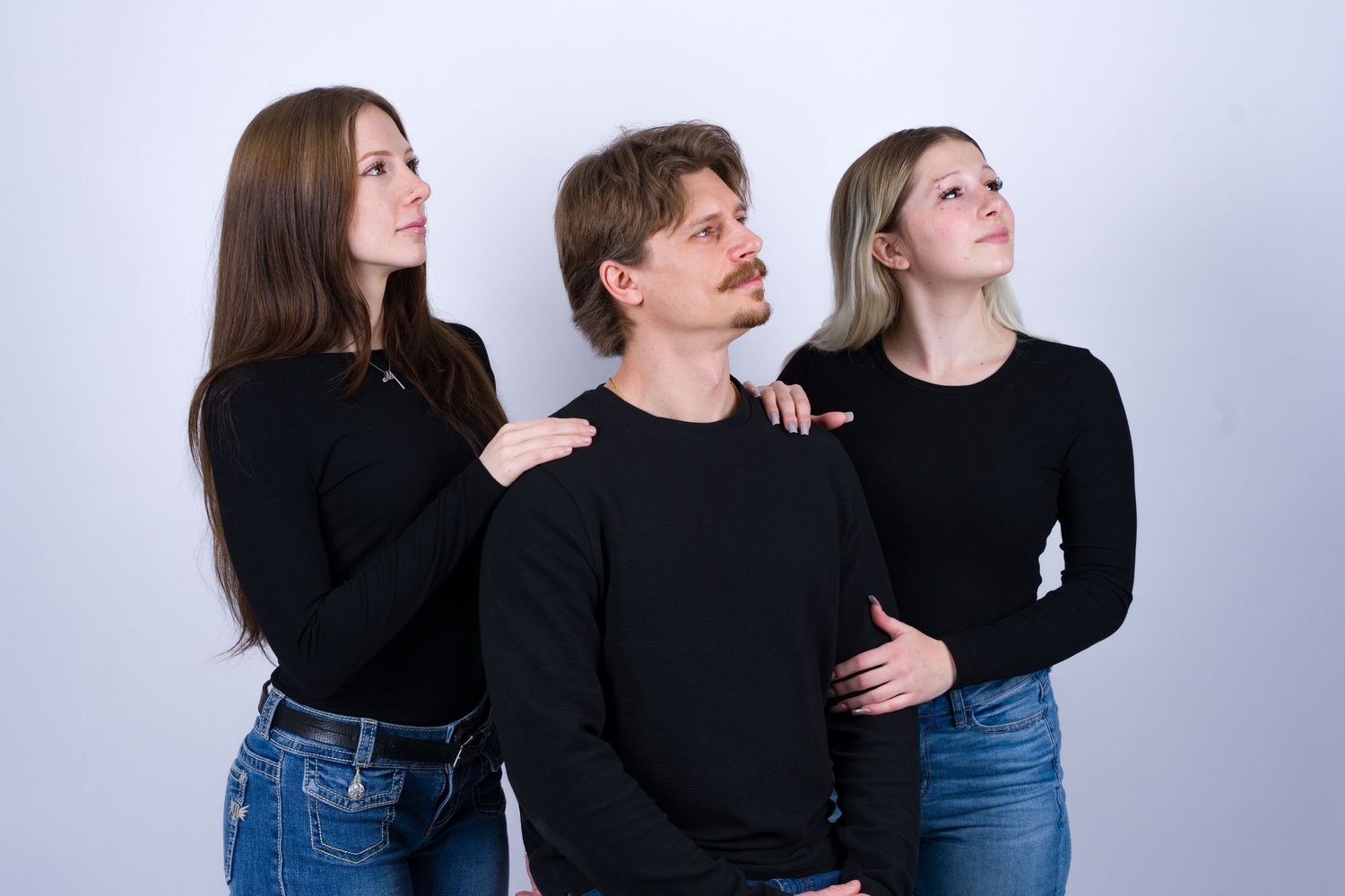 Five progressive photos show two people in black and denim posing playfully against a white background.