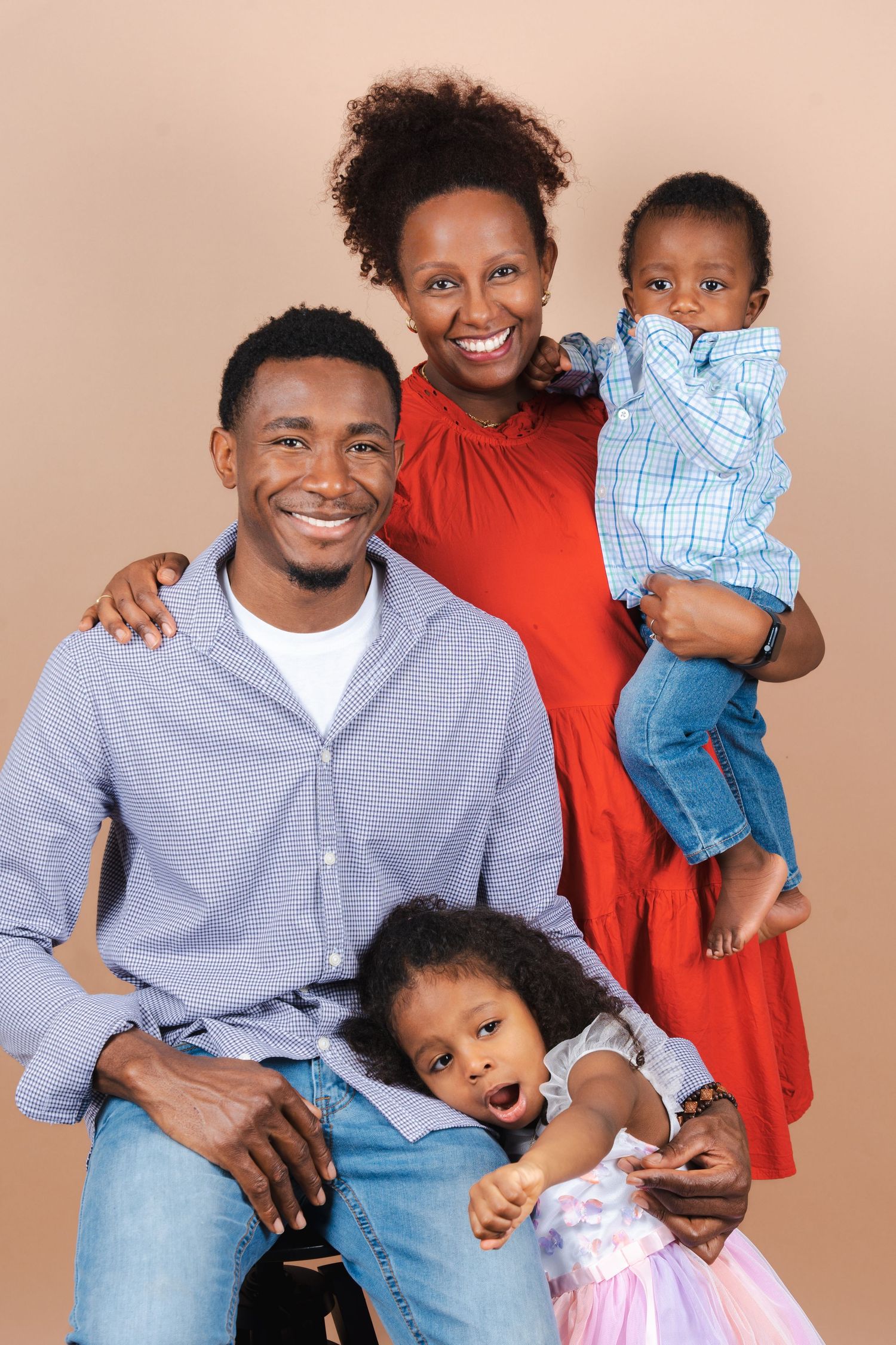 A family of four poses together in a series of studio portraits against a neutral beige background.