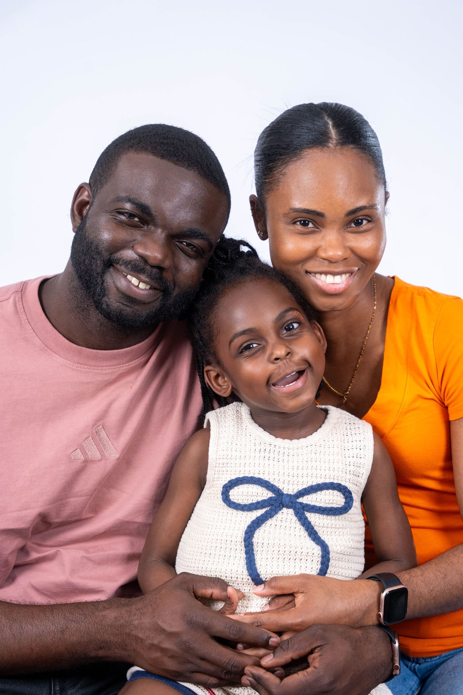 A family poses together in a series of four loving portraits showing closeness and affection.