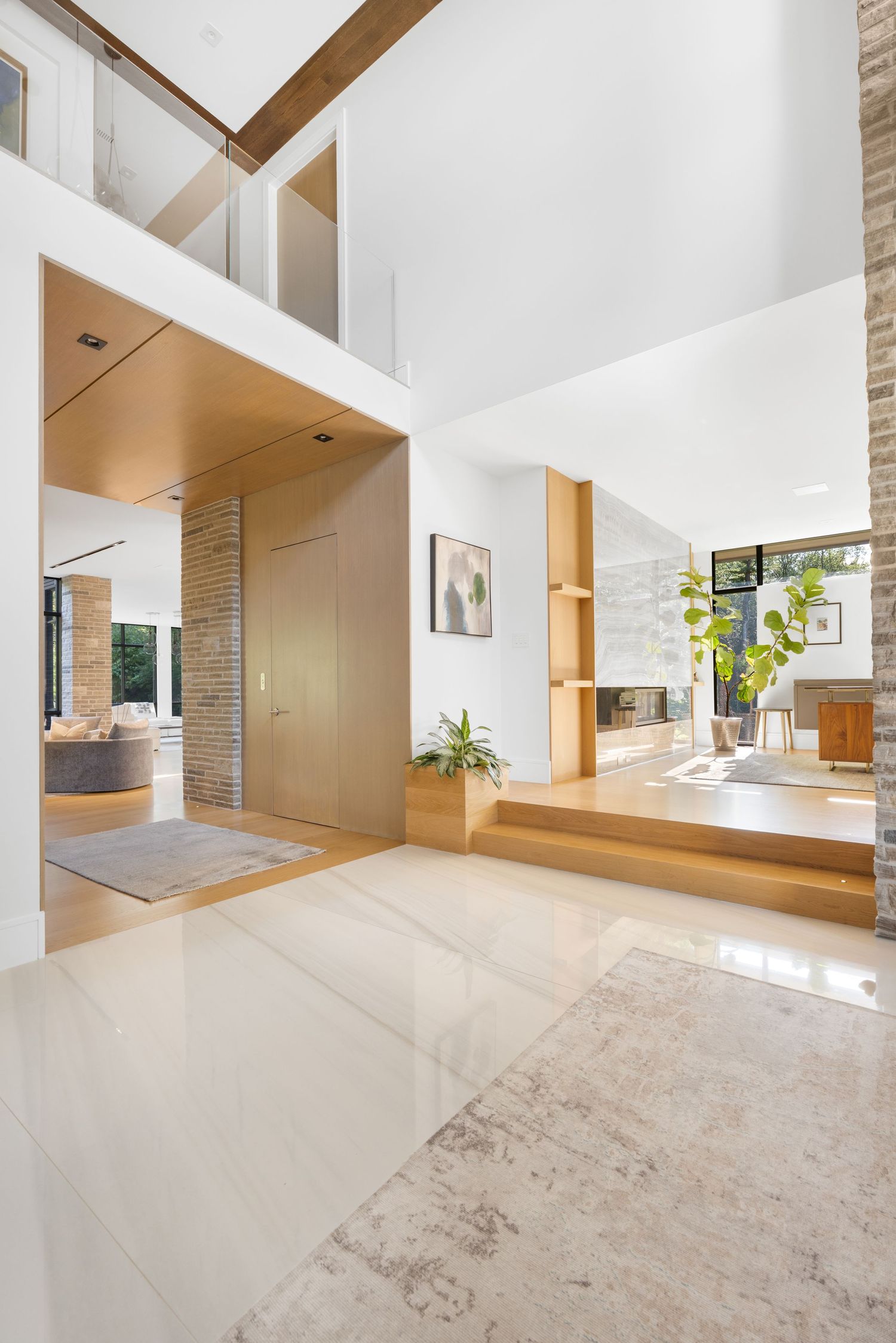 Modern minimalist interior with white walls, wooden beams and open floor plan design.