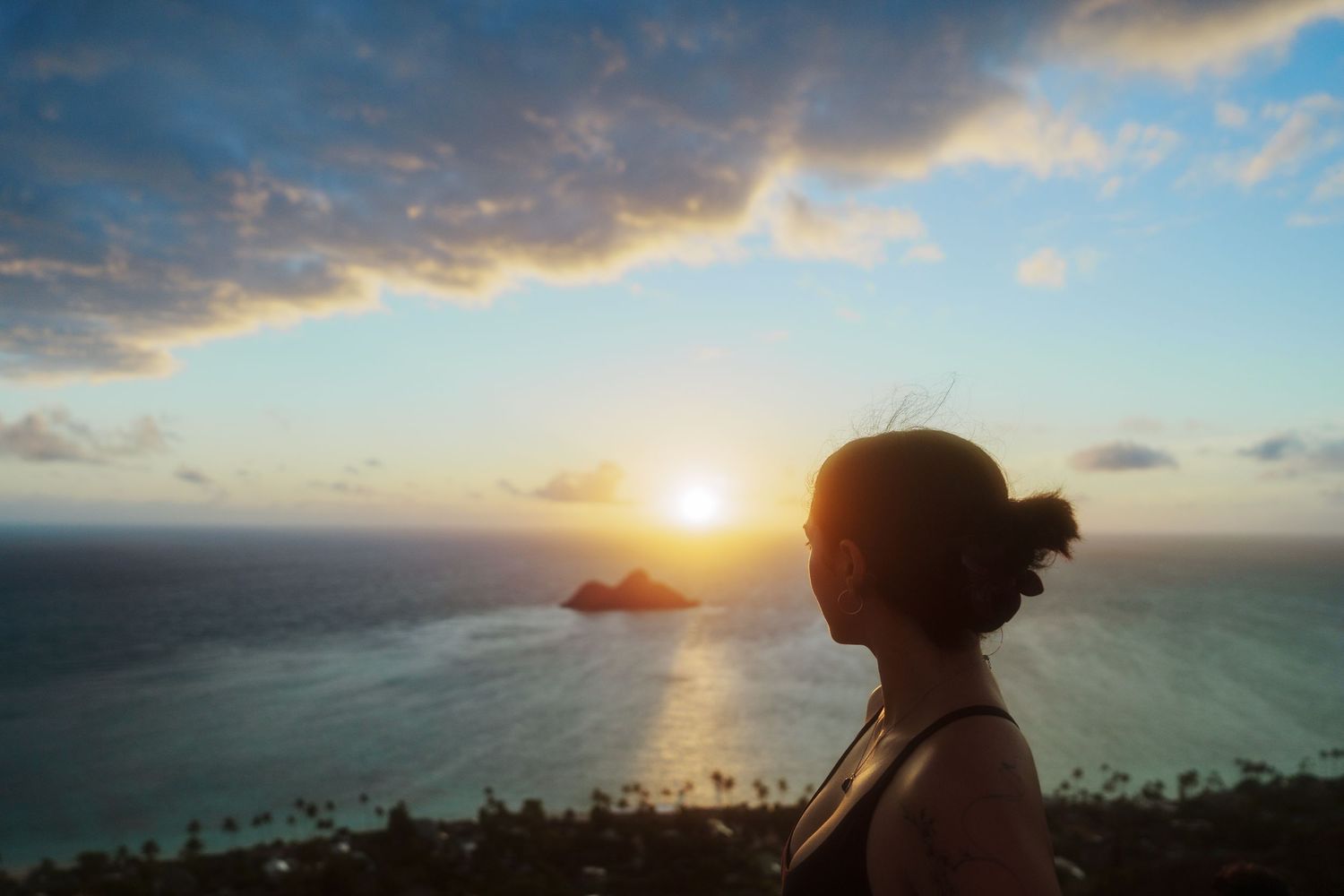 Girl on a Pillbox Hike in Hawaii watching the Sunrise