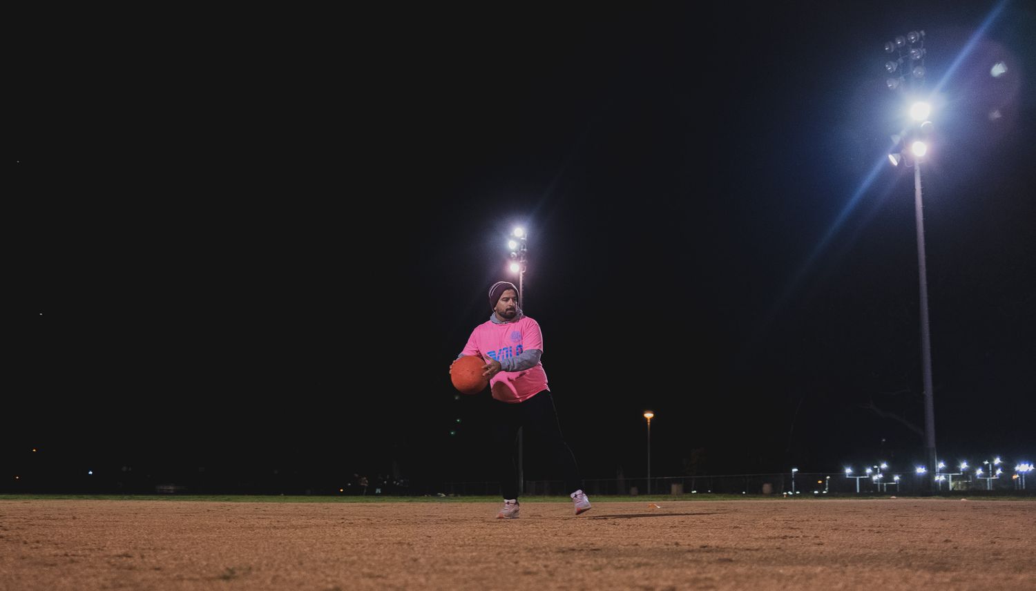 Action shot of a man pitching for kickball