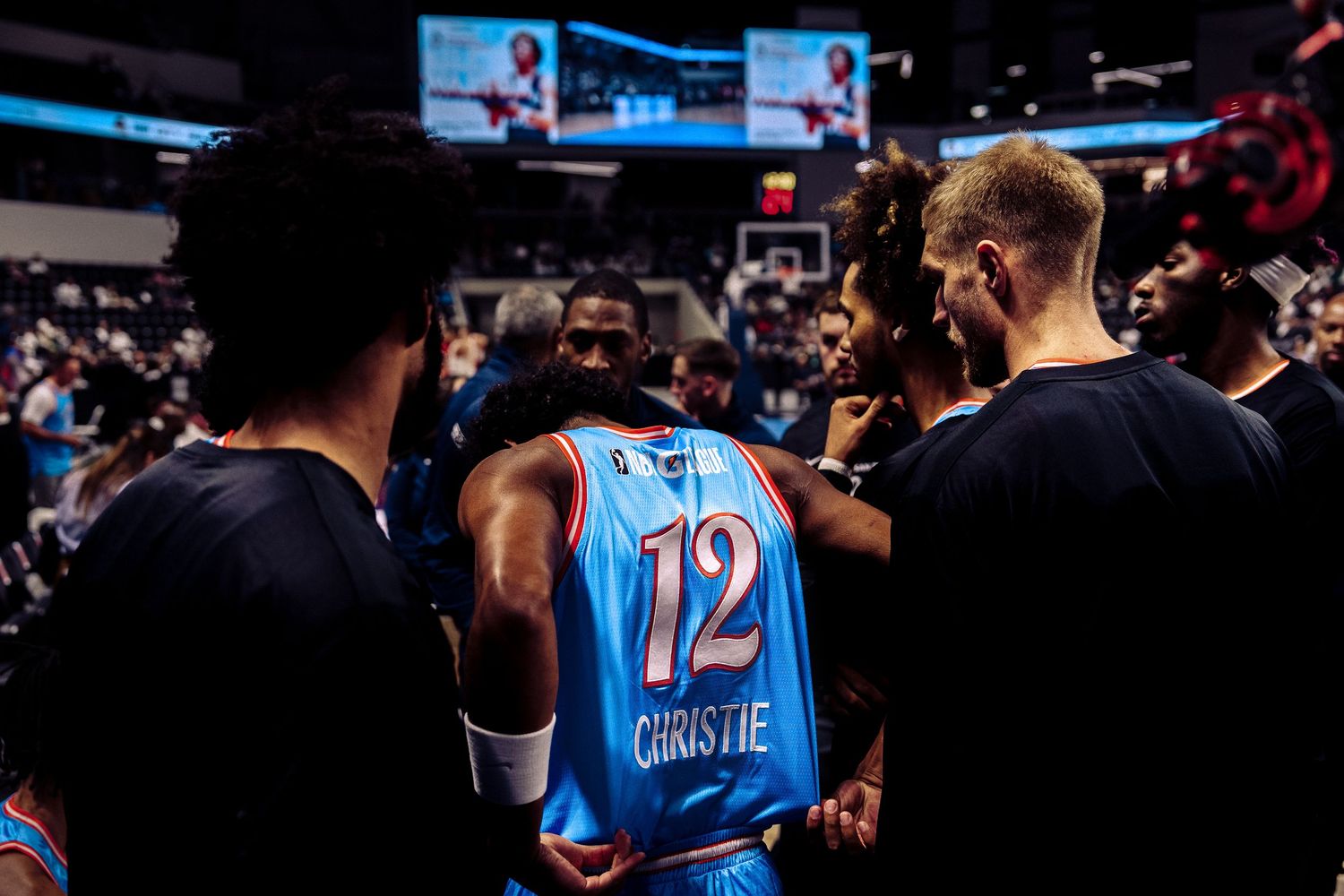 Cam Christie in a basketball huddle for the San Diego Clippers.