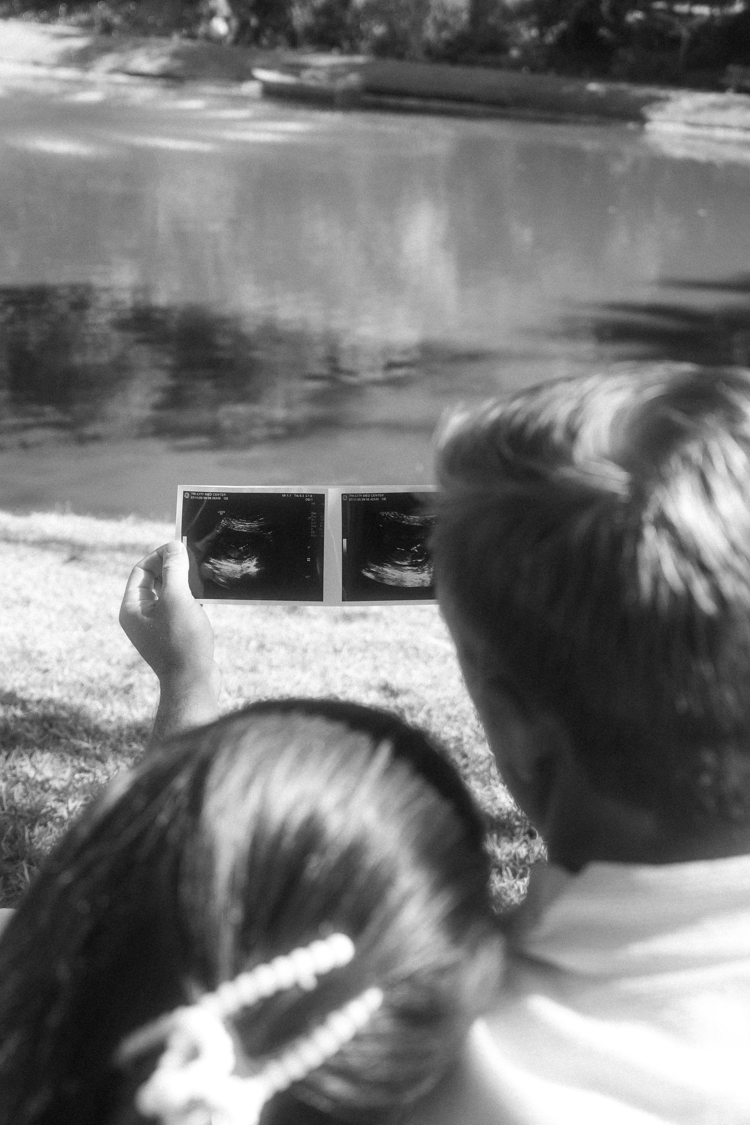 couple staring at ultrasound picture for a baby announcement photoshoot