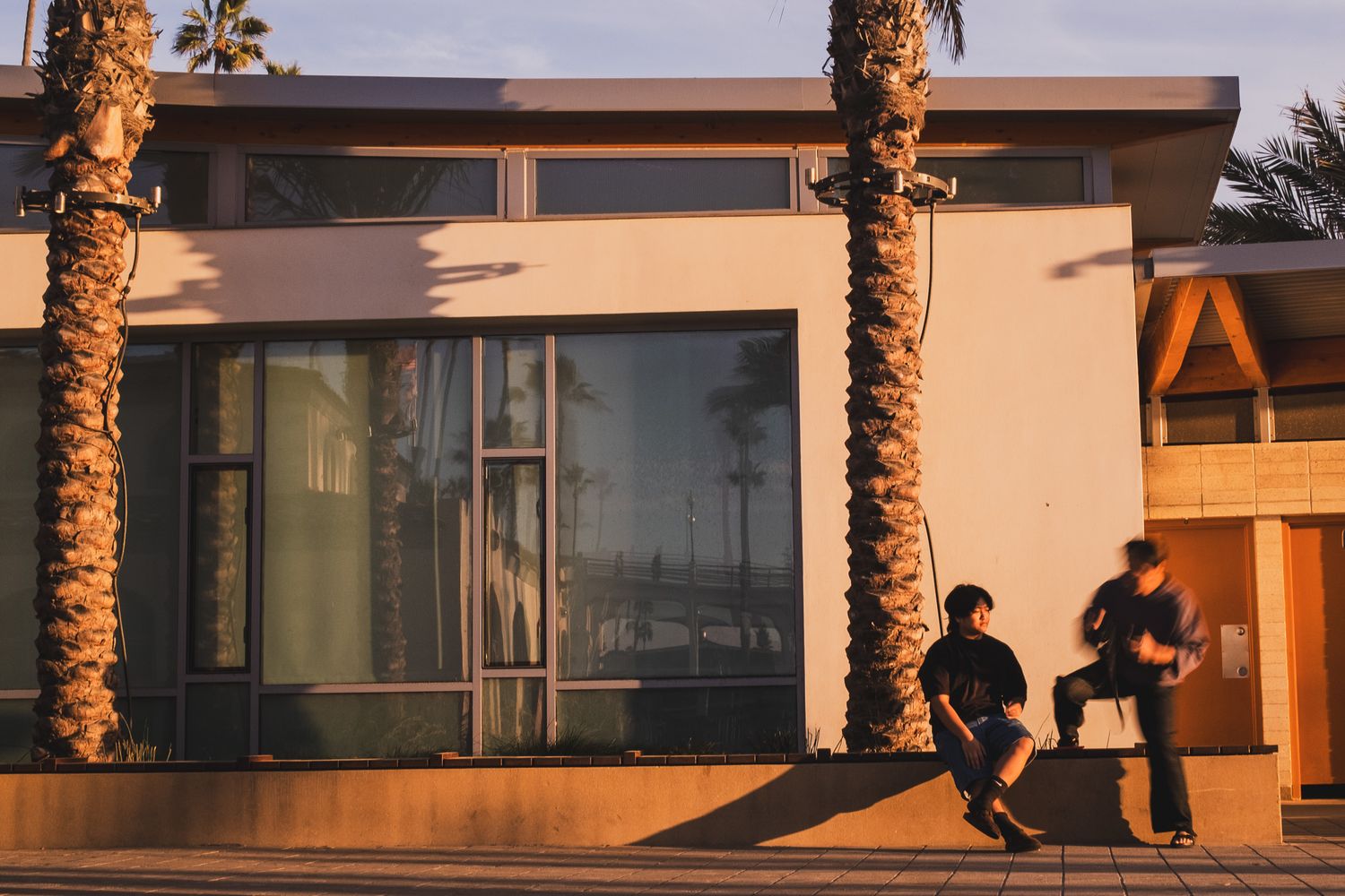 photo of 2 men sitting down at the beach