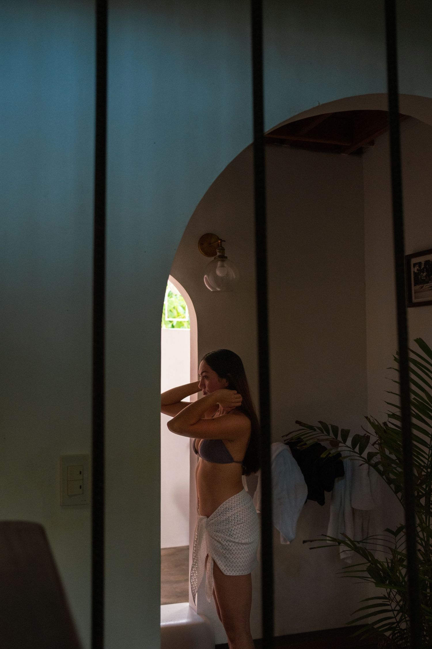 photo of a pretty Girl looking at herself in the mirror, taken by someone else