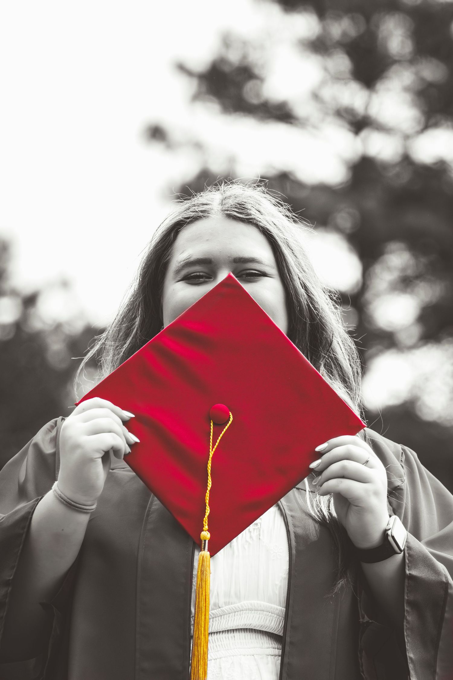 A photo of a lady in her cap and gown for graduation.