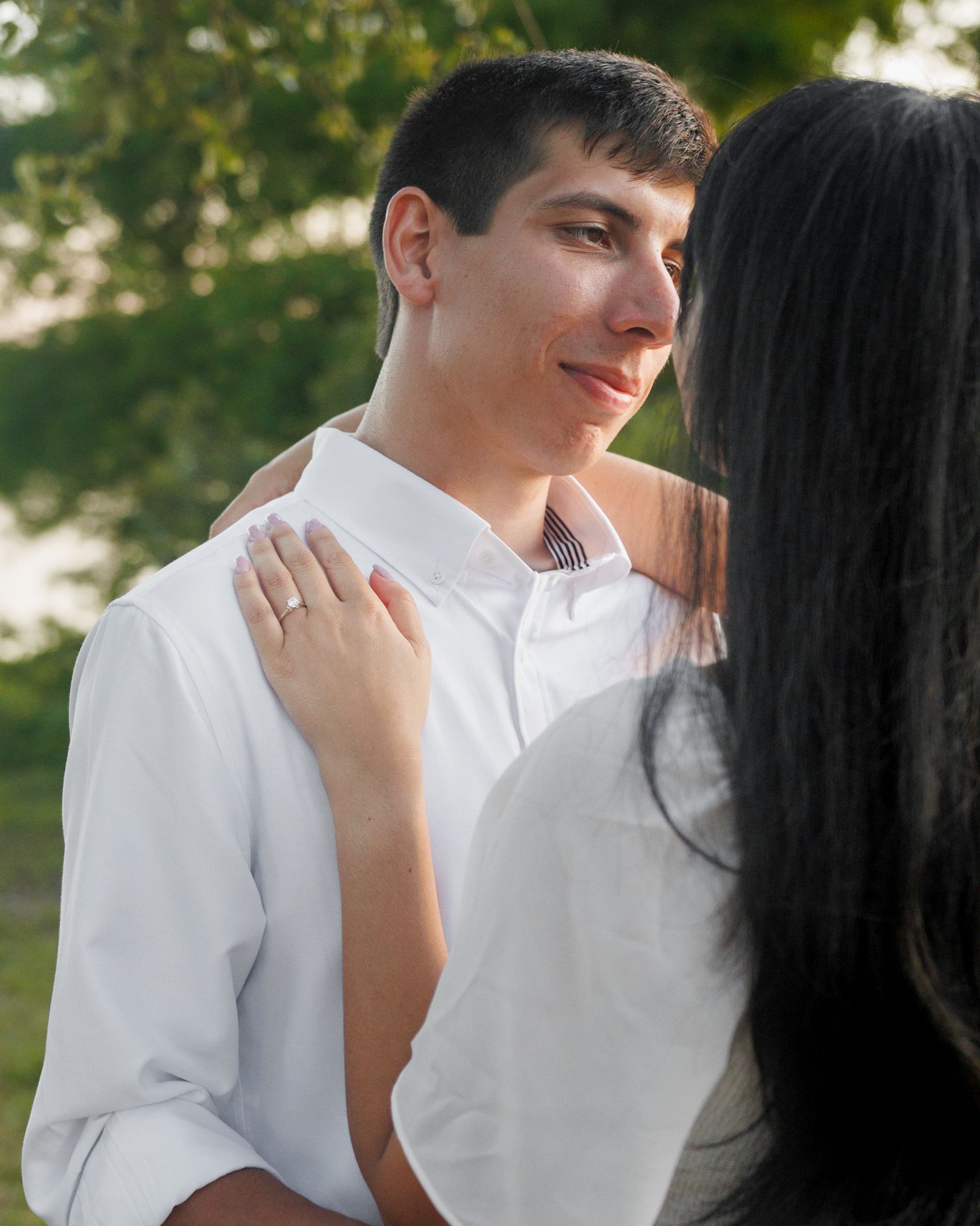 A couple posing with the guy looking into the girl's eyes