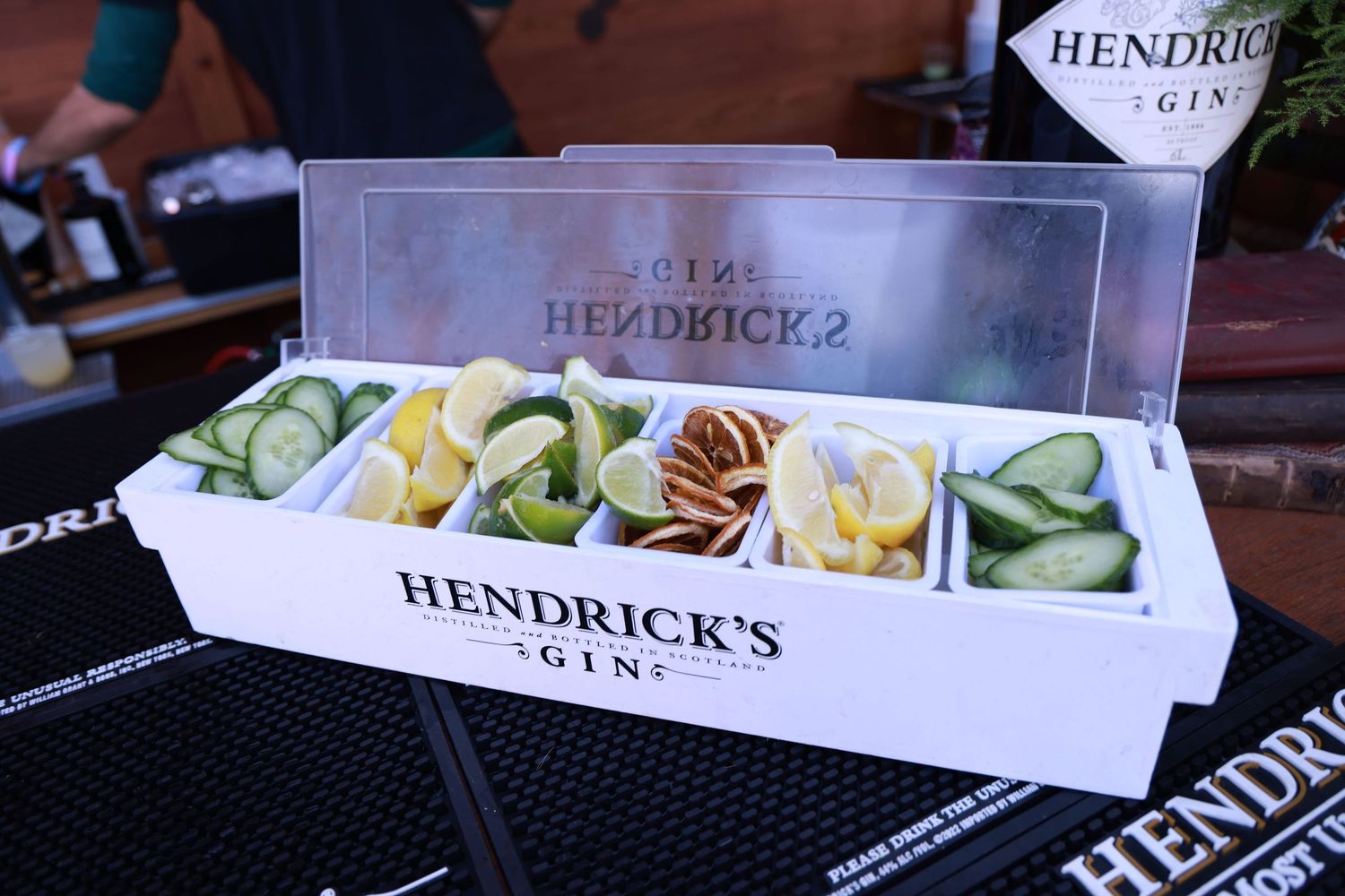 Close-up of Hendrick's Gin branded presentation boxes with garnish ingredients.