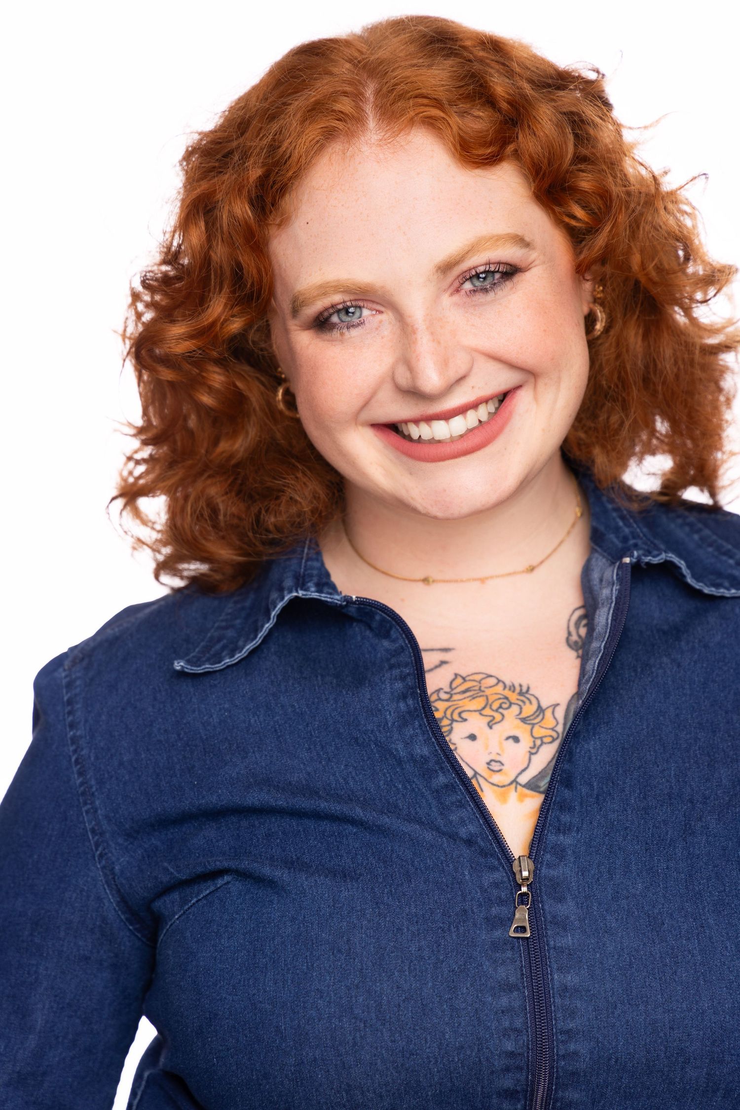 Portrait series in denim jacket showing curly red hair against white backdrop.