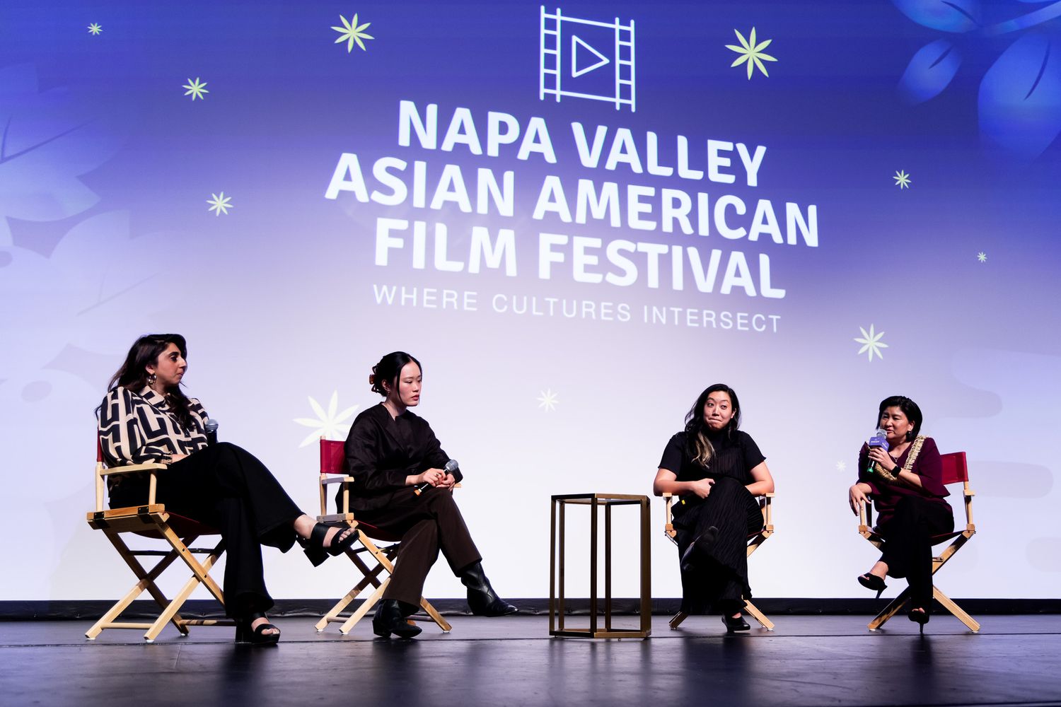 Film festival attendees gather in front of a screening backdrop at the Napa Valley Asian American Film Festival.