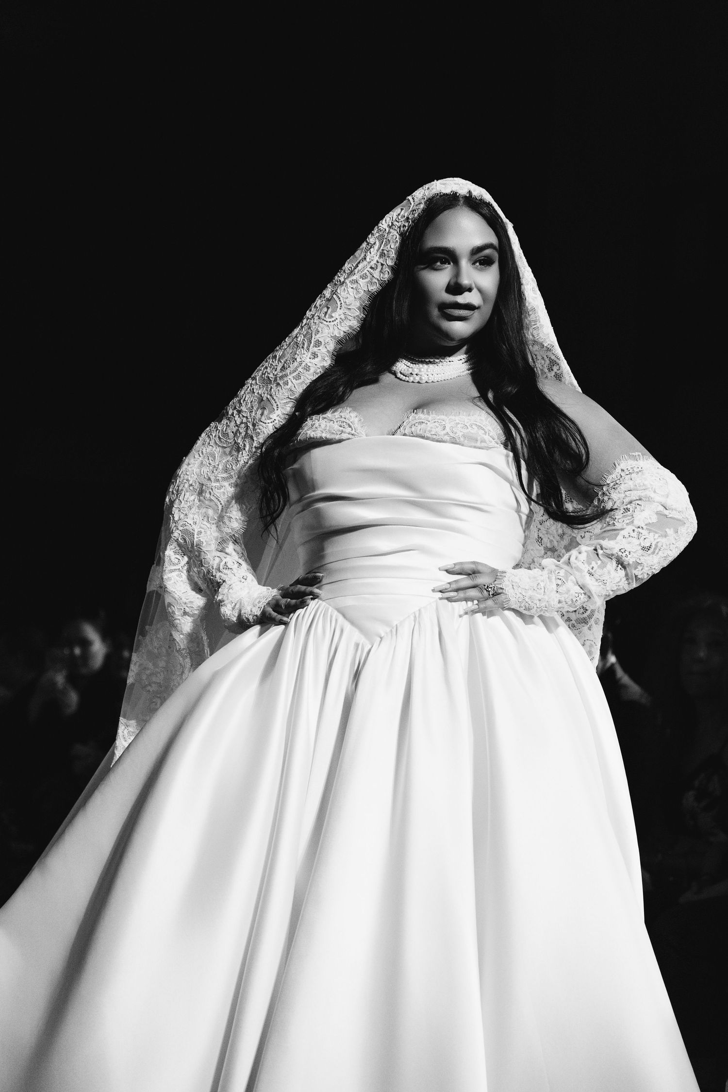 Black and white fashion photo series showing different poses in a flowing white wedding dress with lace sleeves.