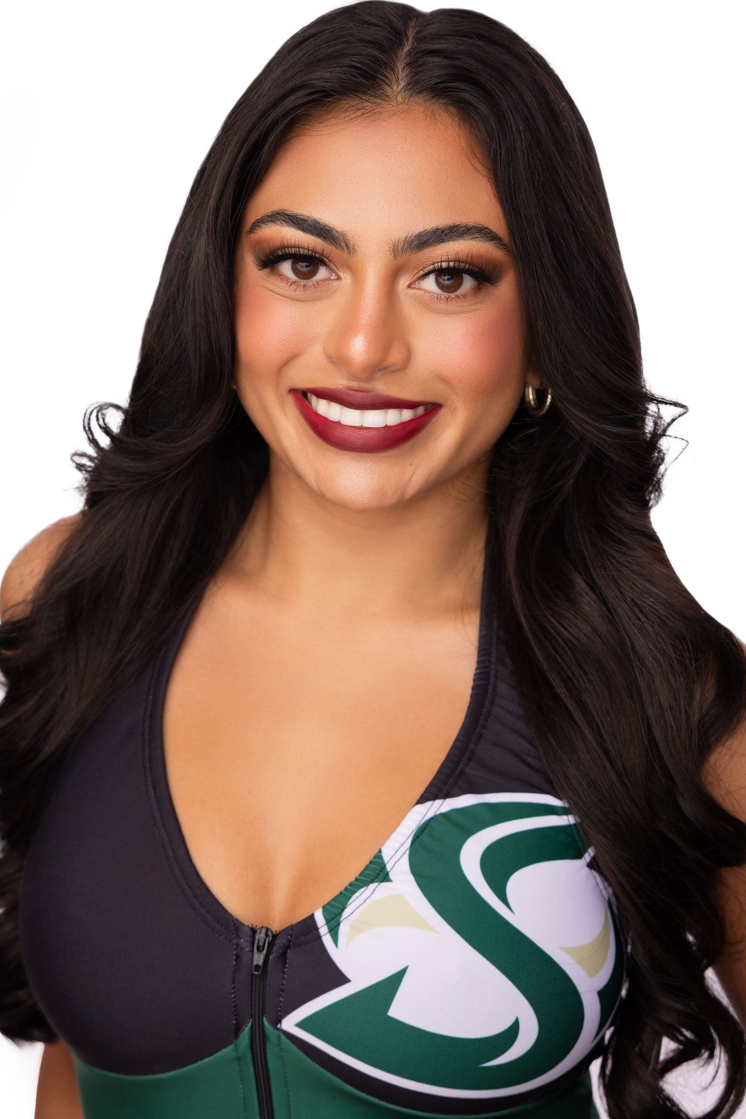 Glamour portraits in black athletic top with dark wavy hair and bold lipstick.