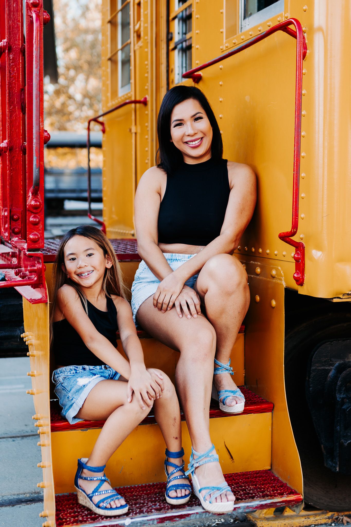 A series of three similar photos showing someone sitting on yellow train car steps wearing denim shorts and sandals.
