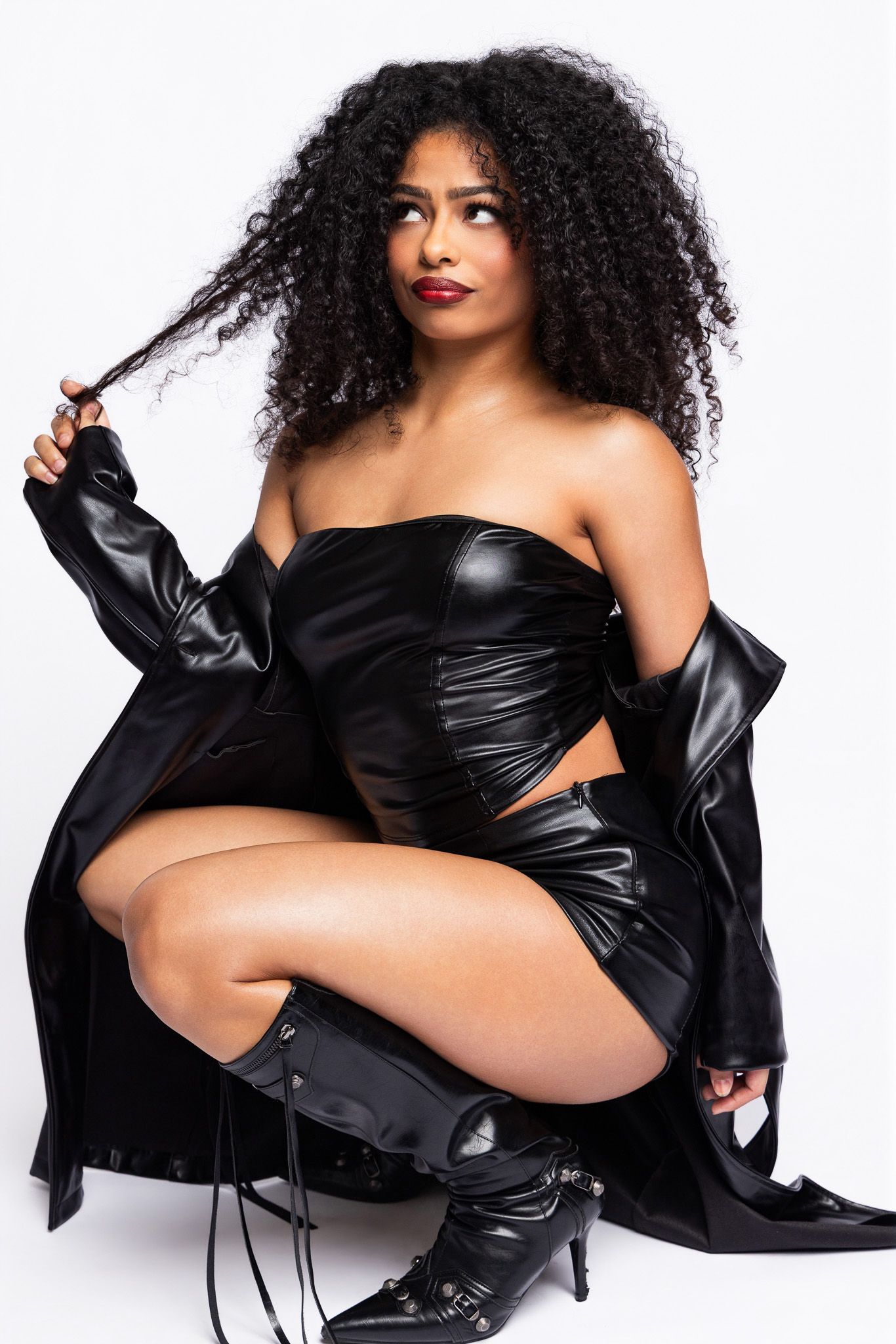 Fashion photo series featuring black leather boots and jacket styled with dramatic poses on white background.