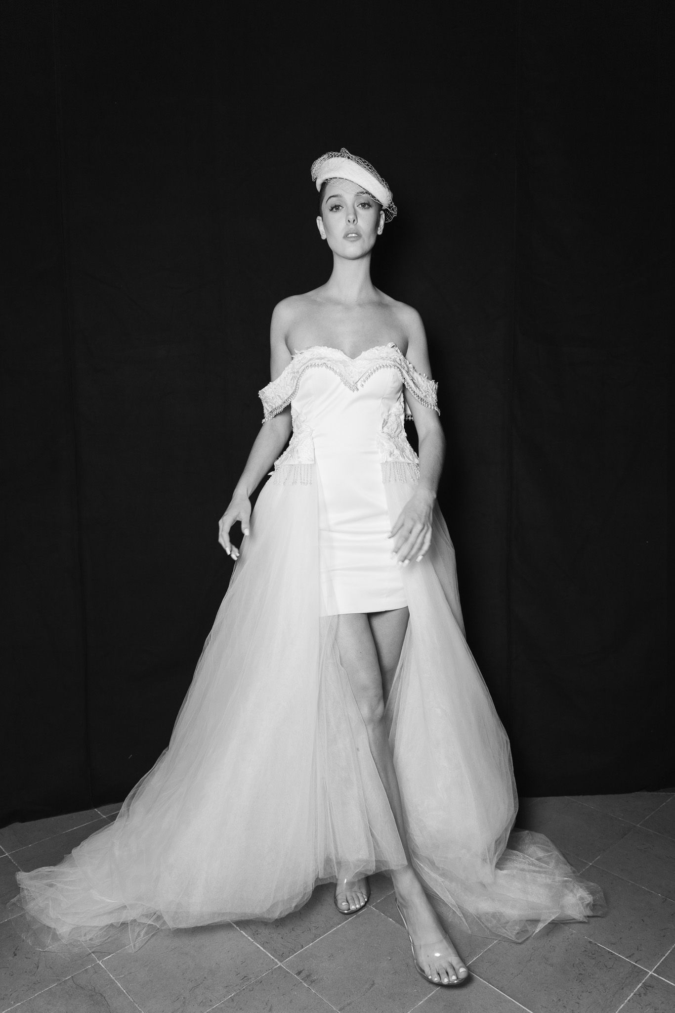 Behind-the-scenes bridal fashion shoot showing flowing white tulle gown details.