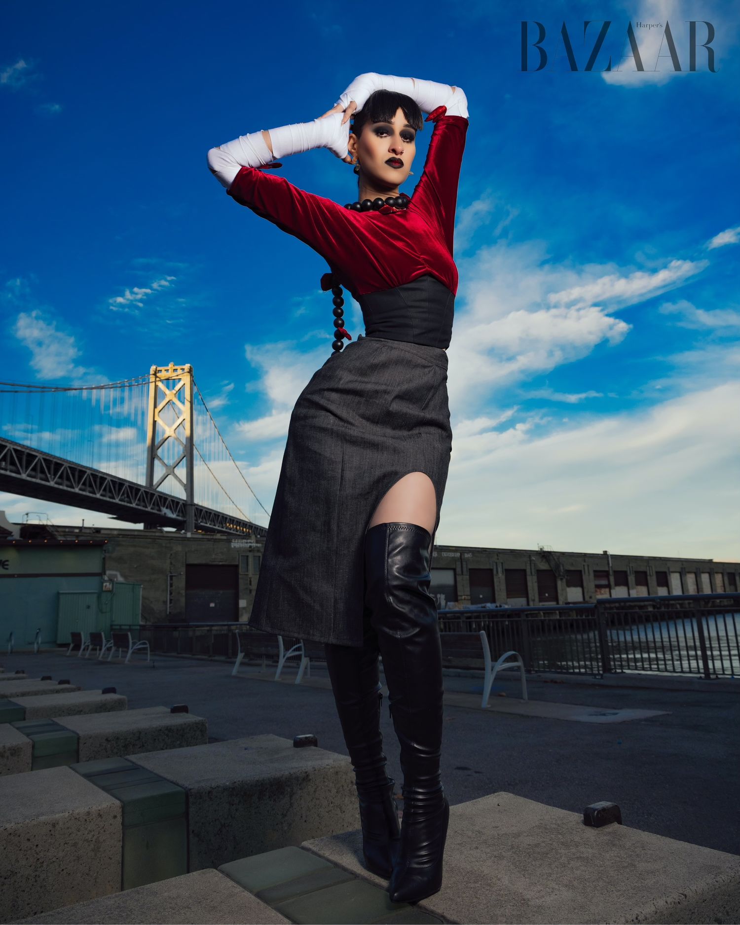 A fashion editorial photo series showing a model in black pants posing against a waterfront backdrop with the Bay Bridge.