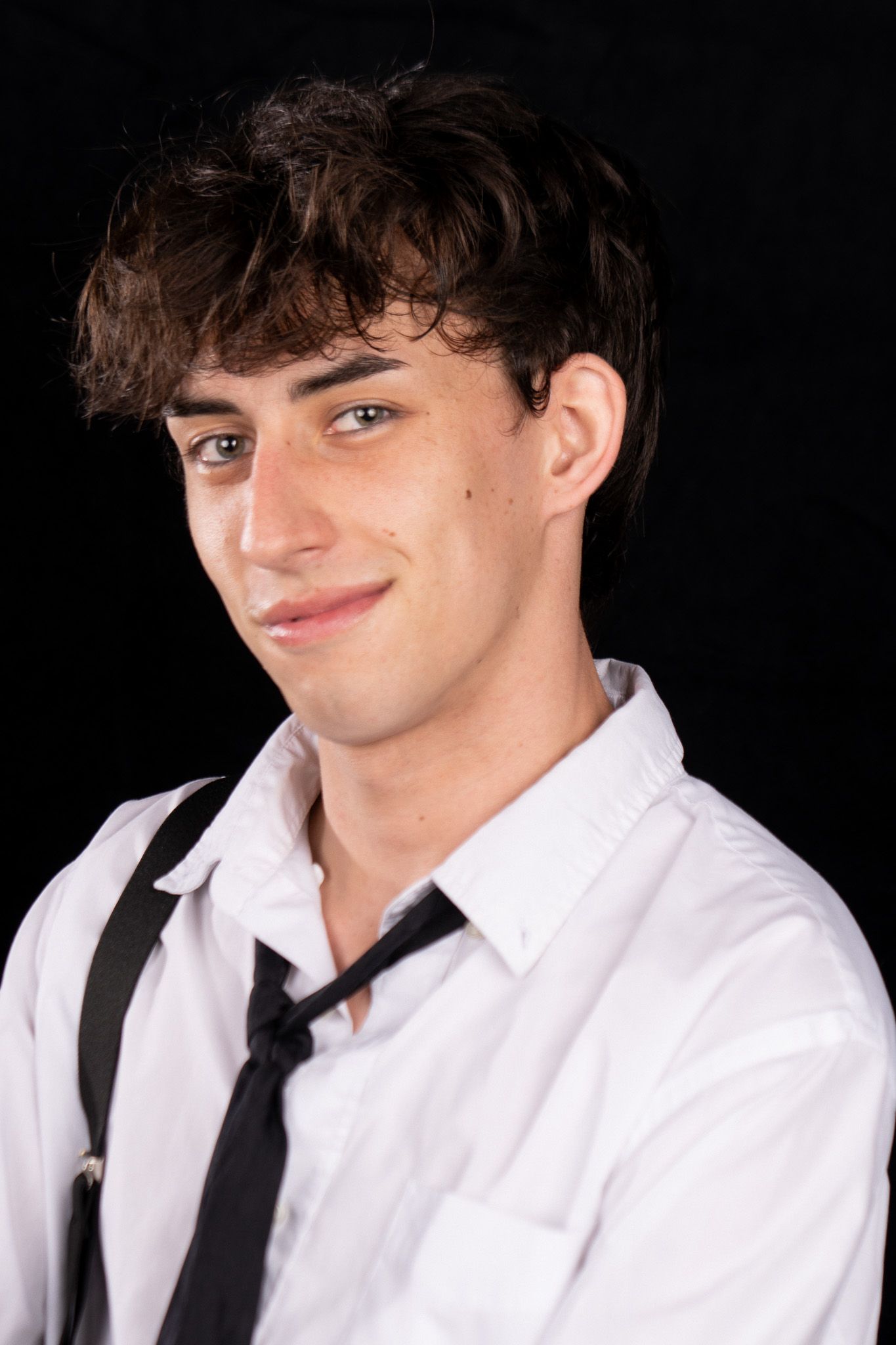 A series of smiling expressions in a white dress shirt and black tie against a dark background.