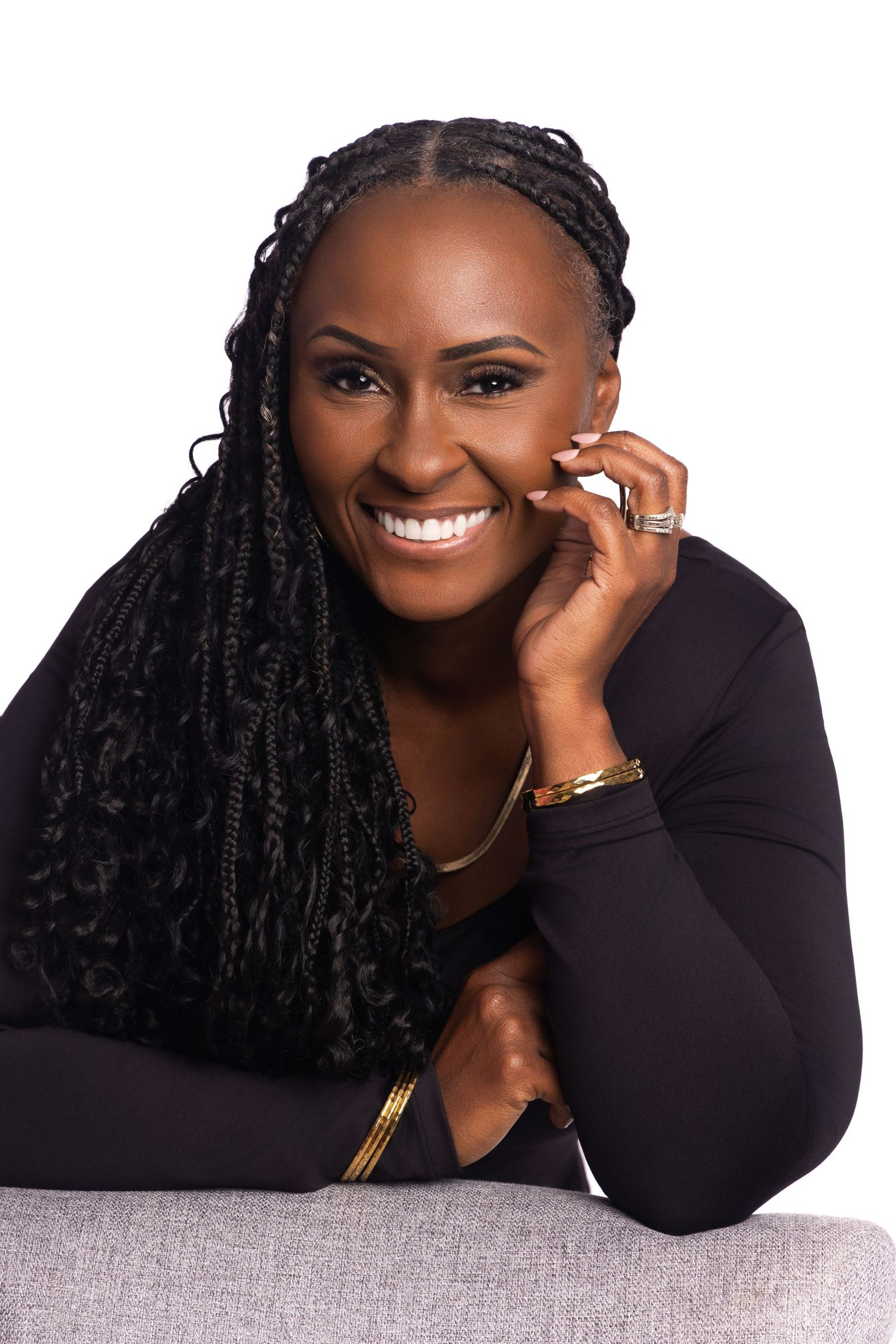 Professional studio portraits showing joyful expressions against light and dark backgrounds while wearing black attire.