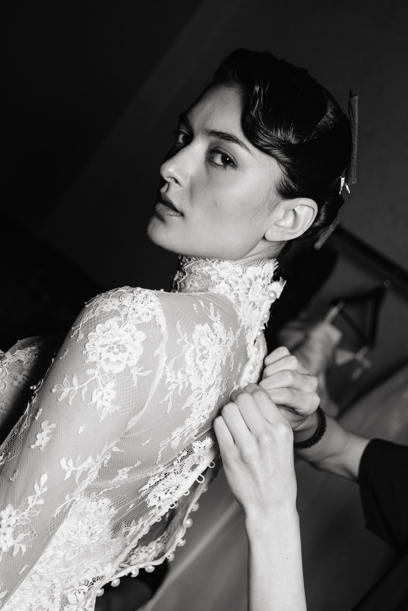 A series of black and white profile portraits showing delicate white lace details against a dark background.