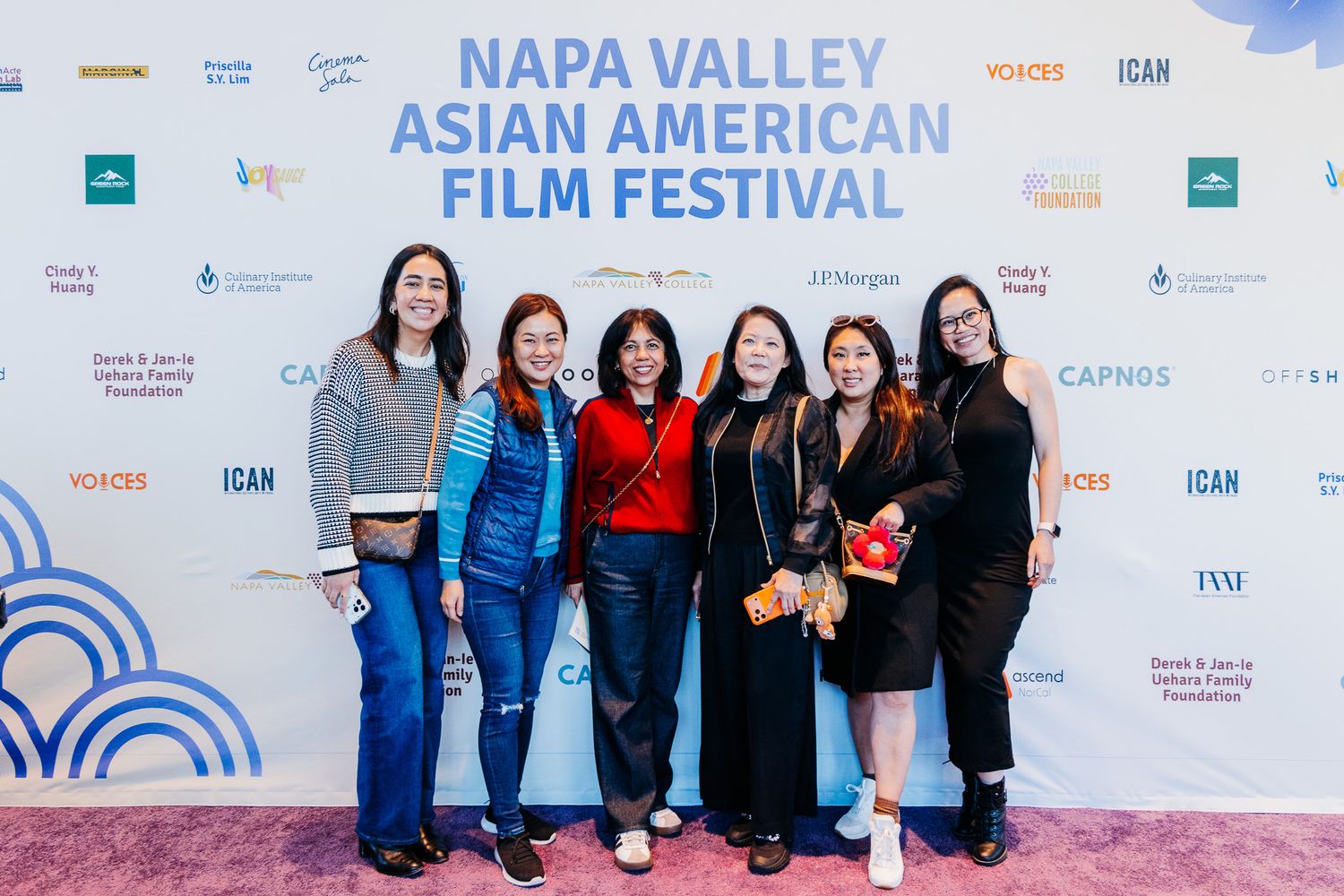 Attendees gather at the Napa Valley Asian American Film Festival with event banners and signage visible in background.