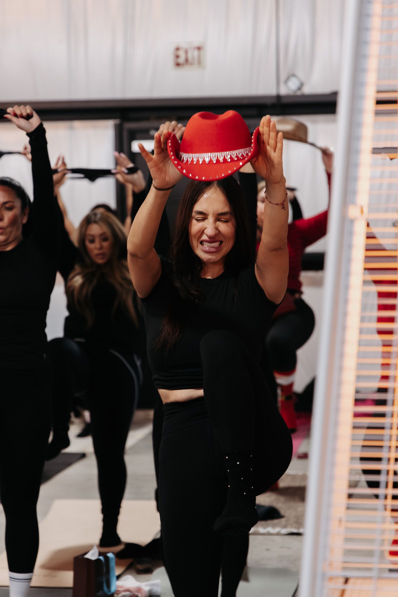 Fitness participants stretching with resistance bands in a studio class.