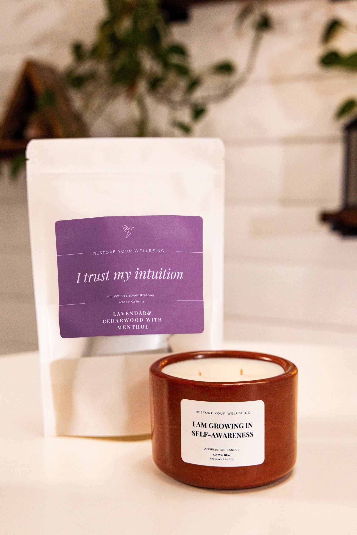 Amber glass candle jars with simple white labels arranged in a clean, modern setting with soft lighting.