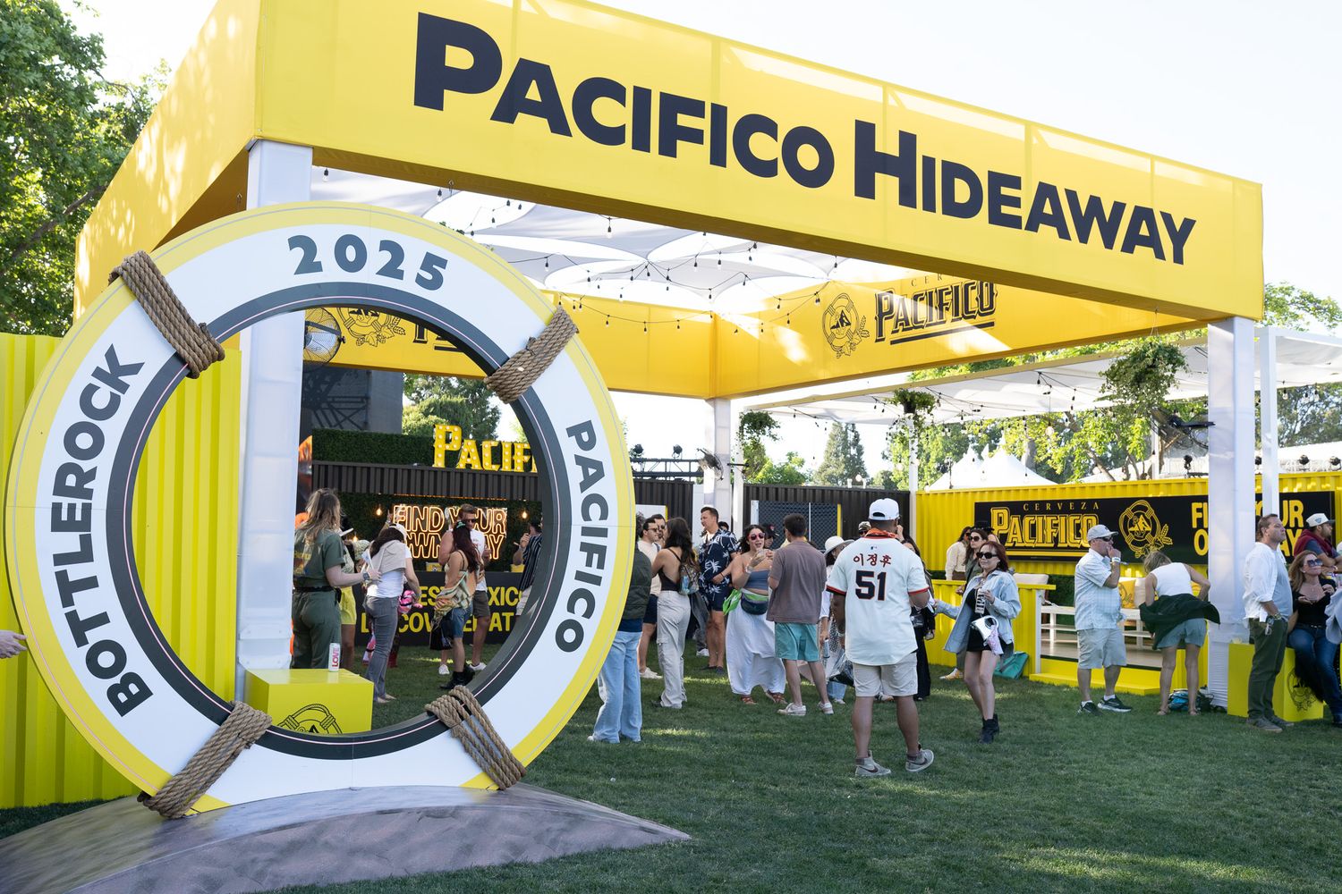 Yellow Pacifico Hideaway branded inflatable archways and tents set up at an outdoor festival event.