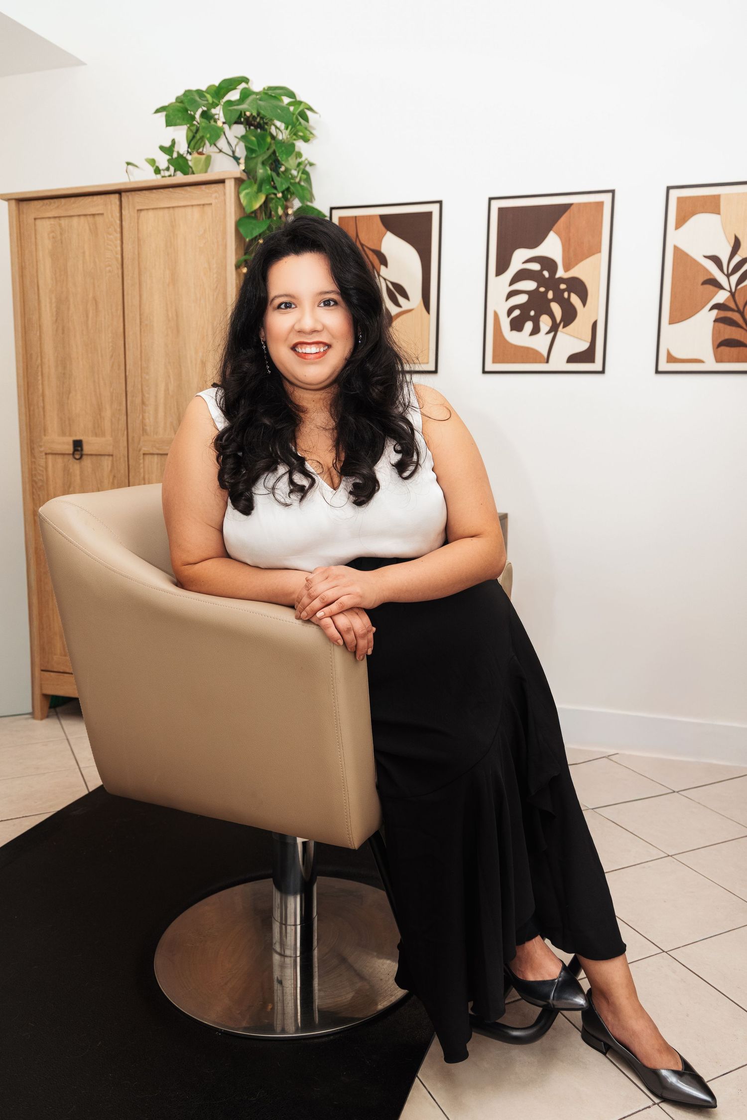 A series of five photos showing a person in black and white attire posing on a beige chair in a modern interior setting.