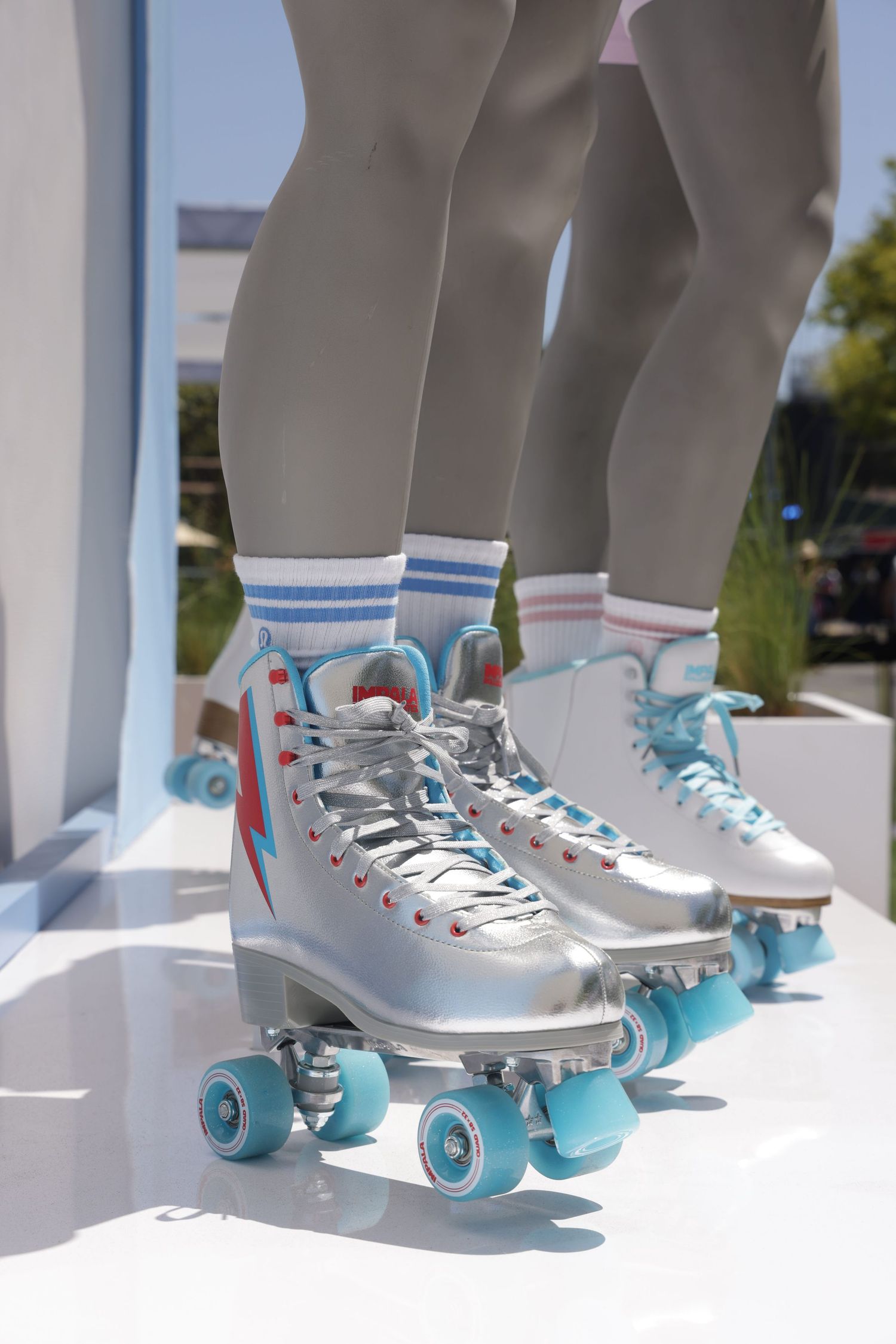 Silver and turquoise roller skates shown in a sequence of close-up shots against a white background.