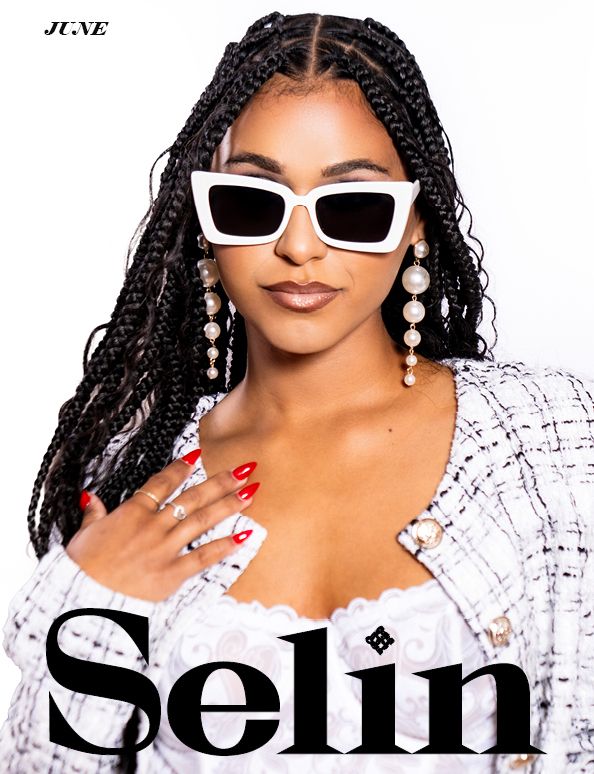 Fashion editorial with white rectangular sunglasses, braided hair, and pearl drop earrings.