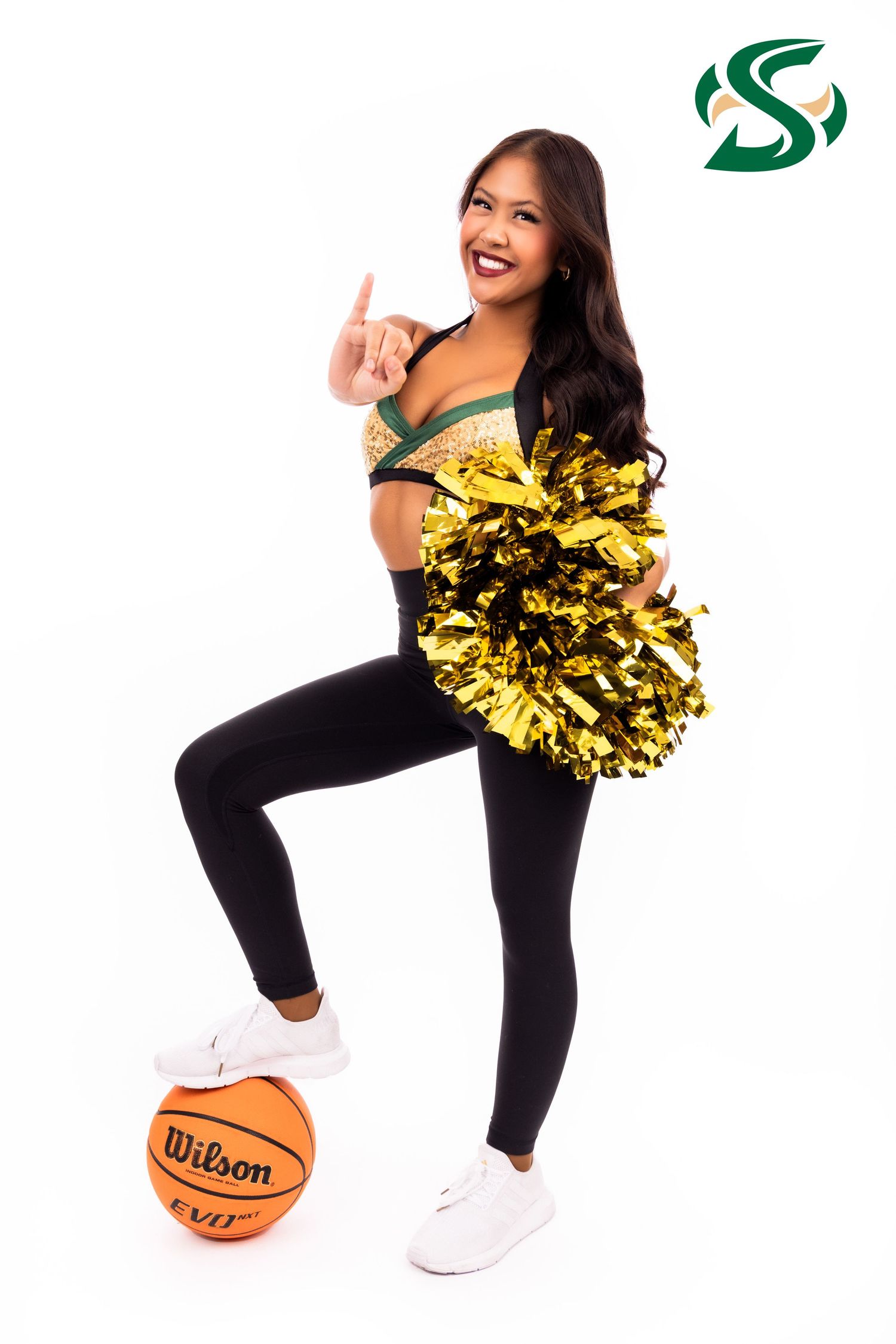 Cheerleader in black outfit strikes dynamic poses with gold pom poms and basketball in white studio setting.