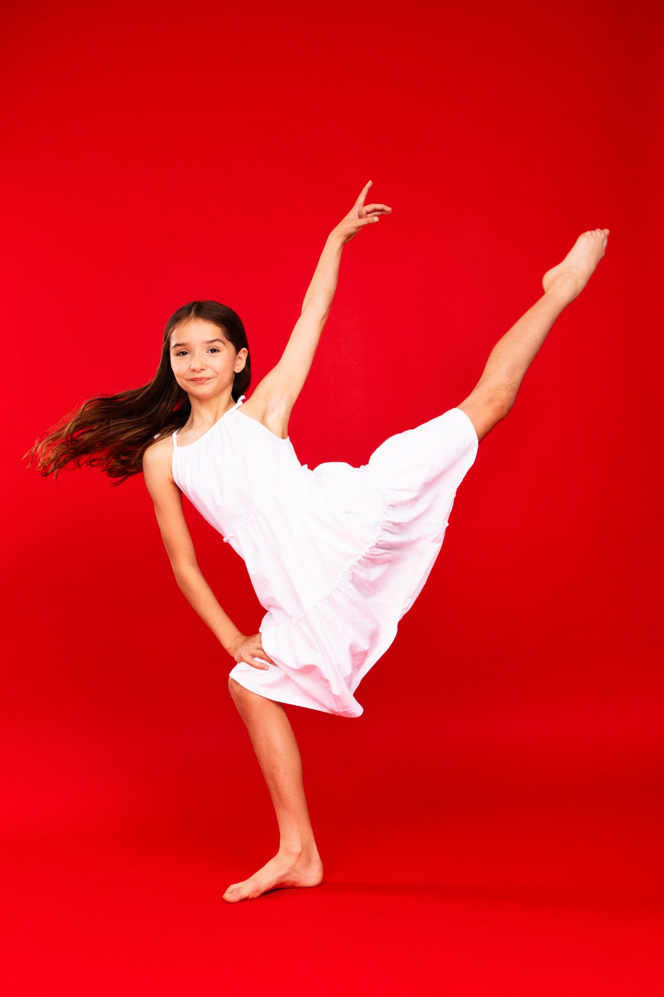 Dancer in white outfit performs dynamic leaps and poses against vibrant red background in sequence of movements.