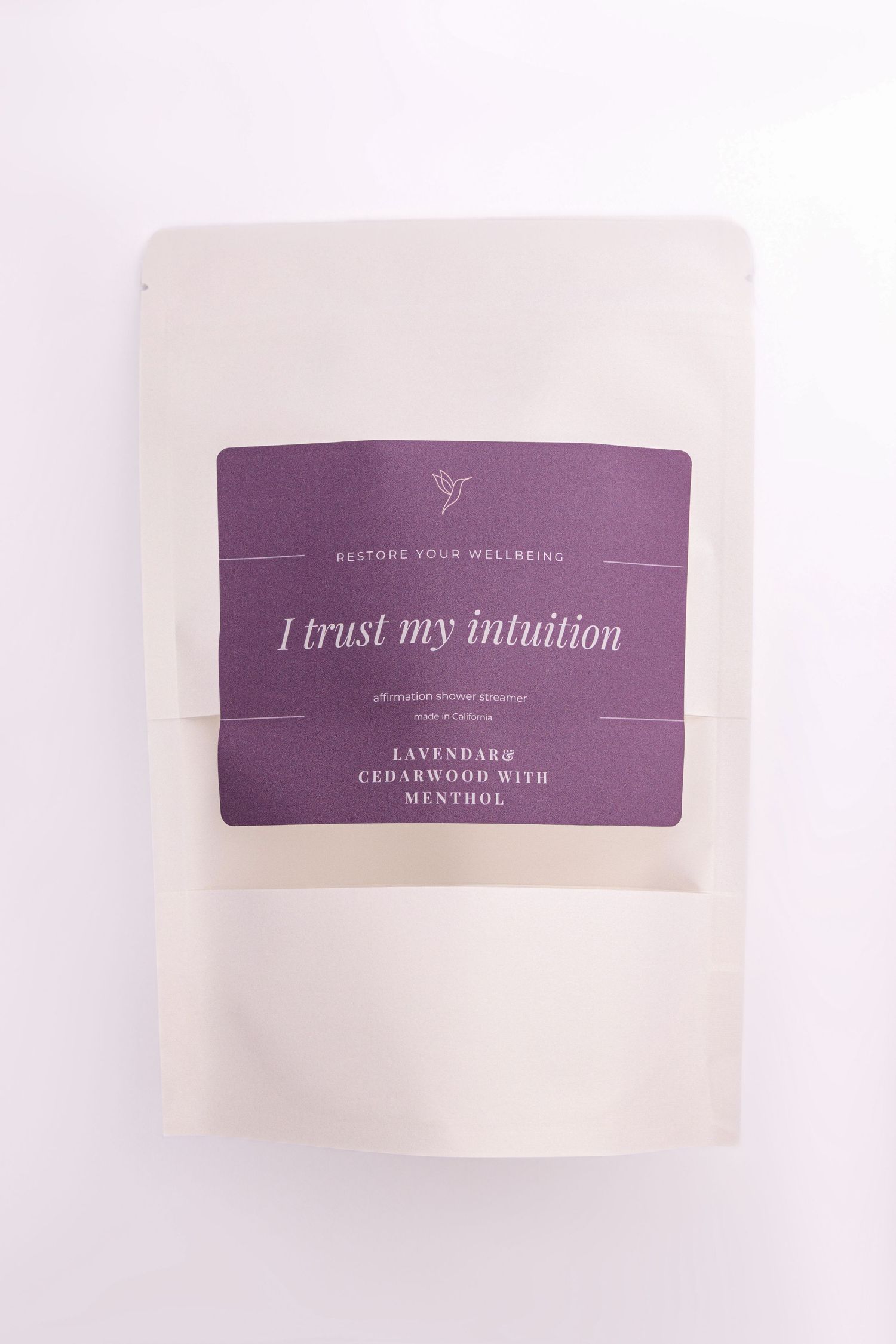 Three purple and white affirmation cards with inspirational text including 'I trust my intuition' displayed on a light surface.